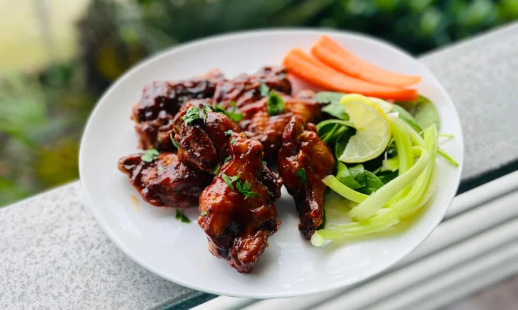 Savory BBQ chicken wings with fresh vegetables