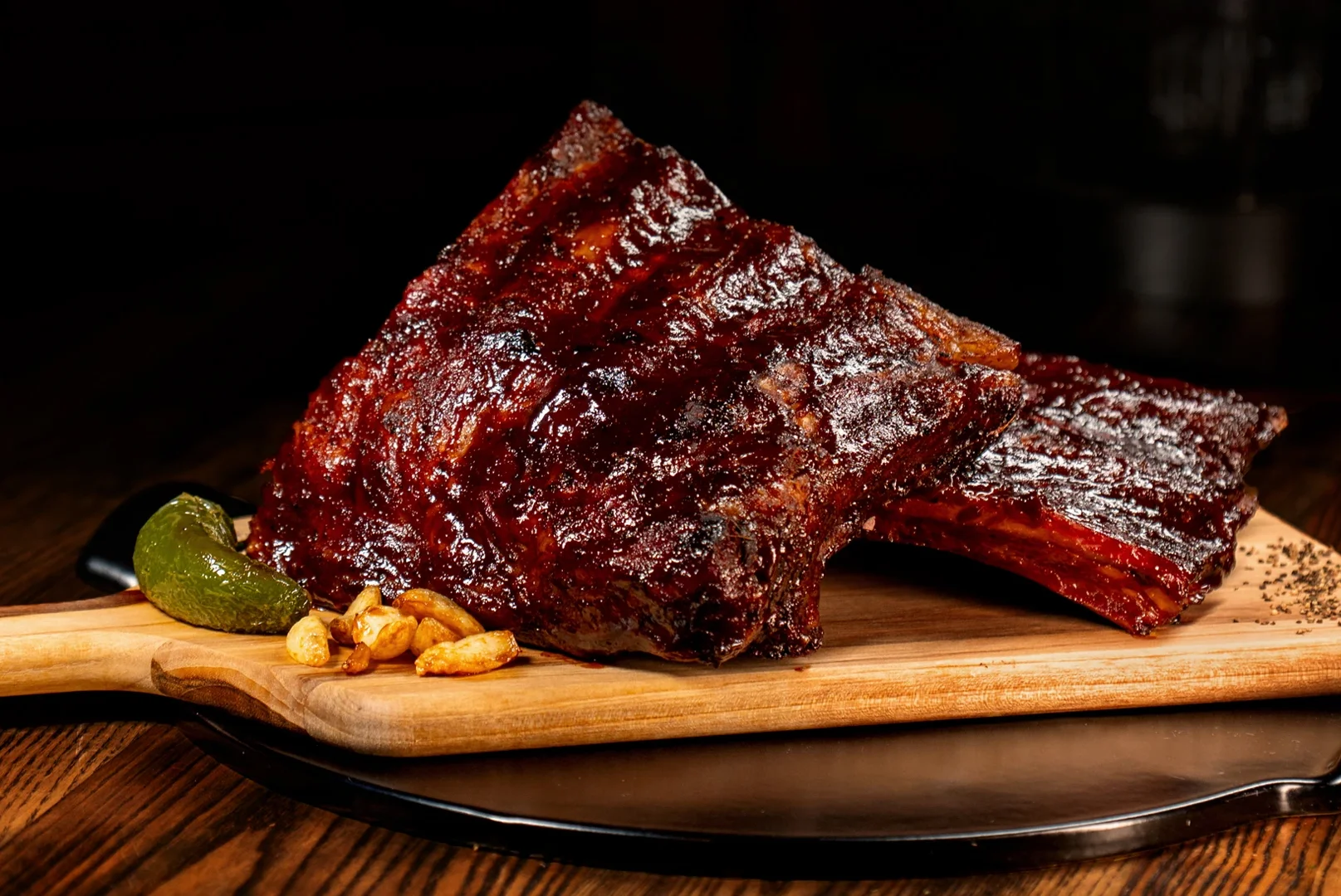 Smoked barbecue ribs served on a wooden platter