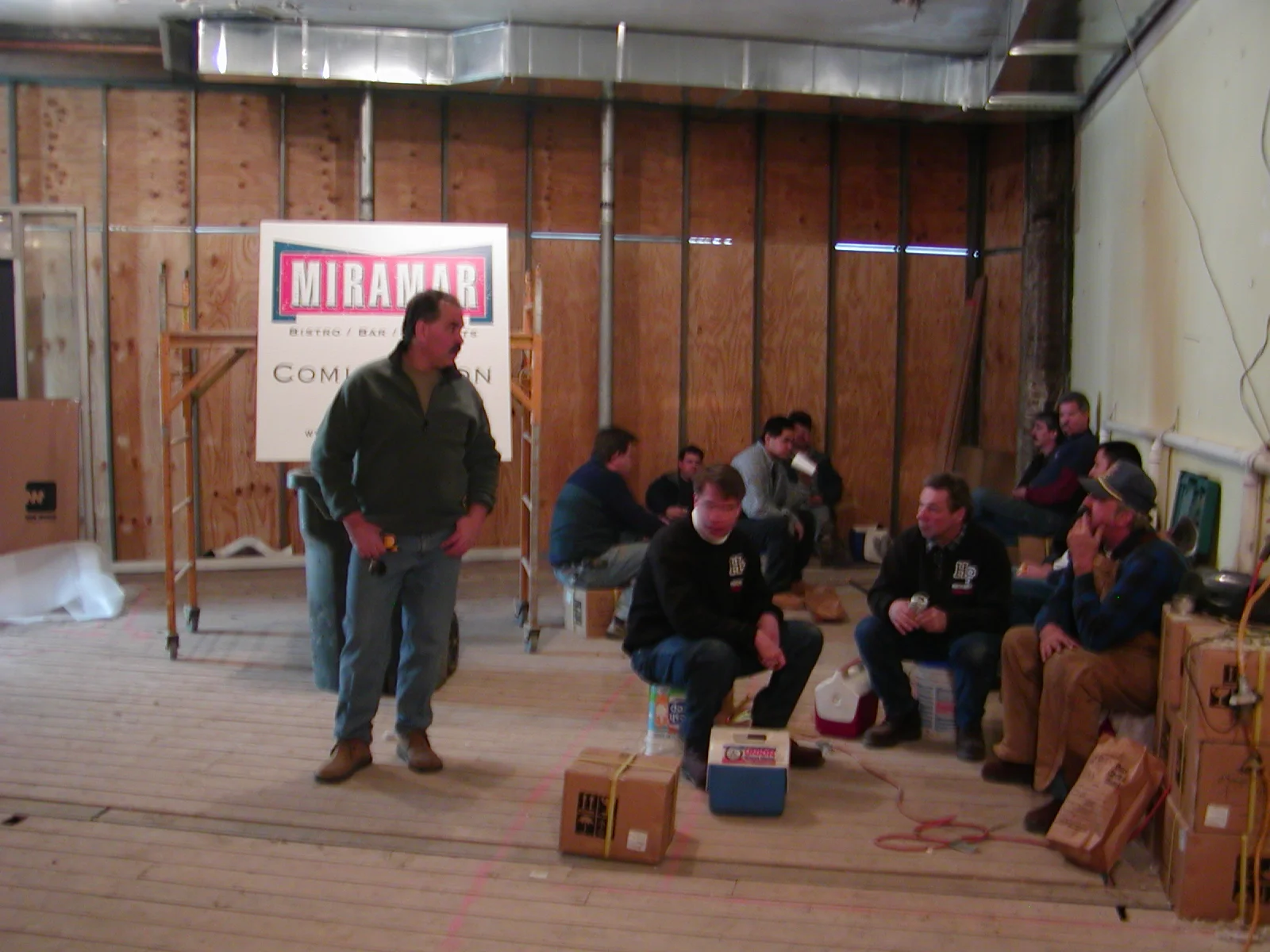 Construction crew preparing for restaurant opening in a rustic interior space
