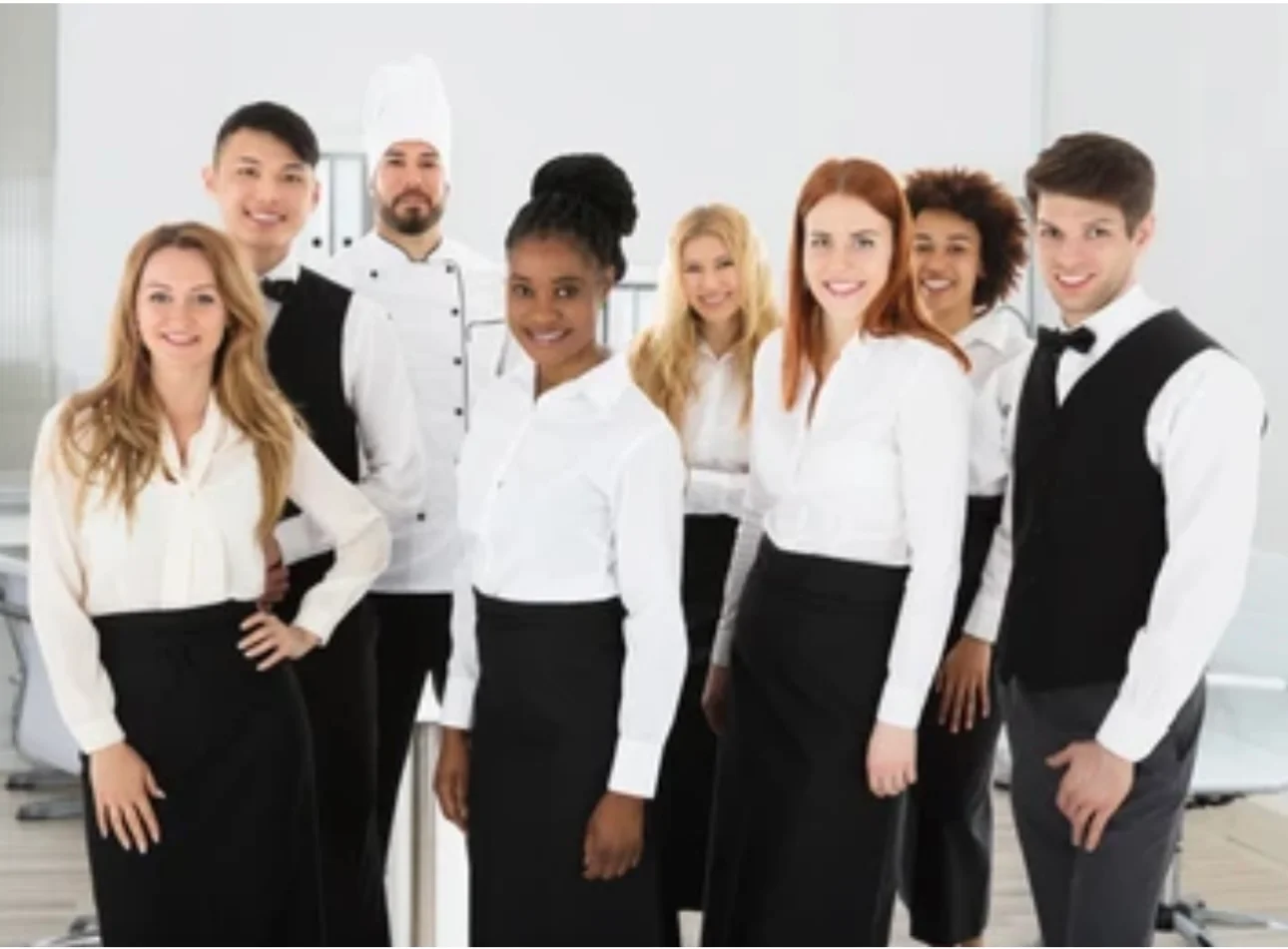 Diverse restaurant staff posing together in a modern dining space