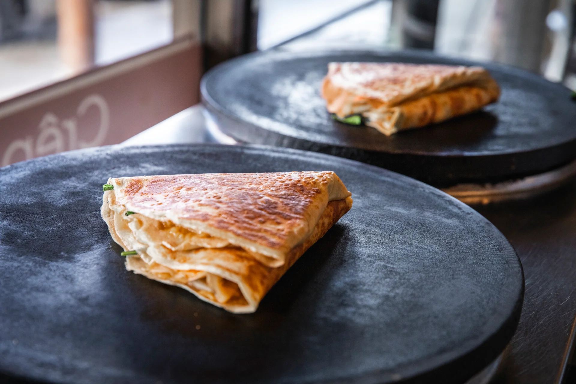 Crispy Chinese scallion pancakes on a griddle