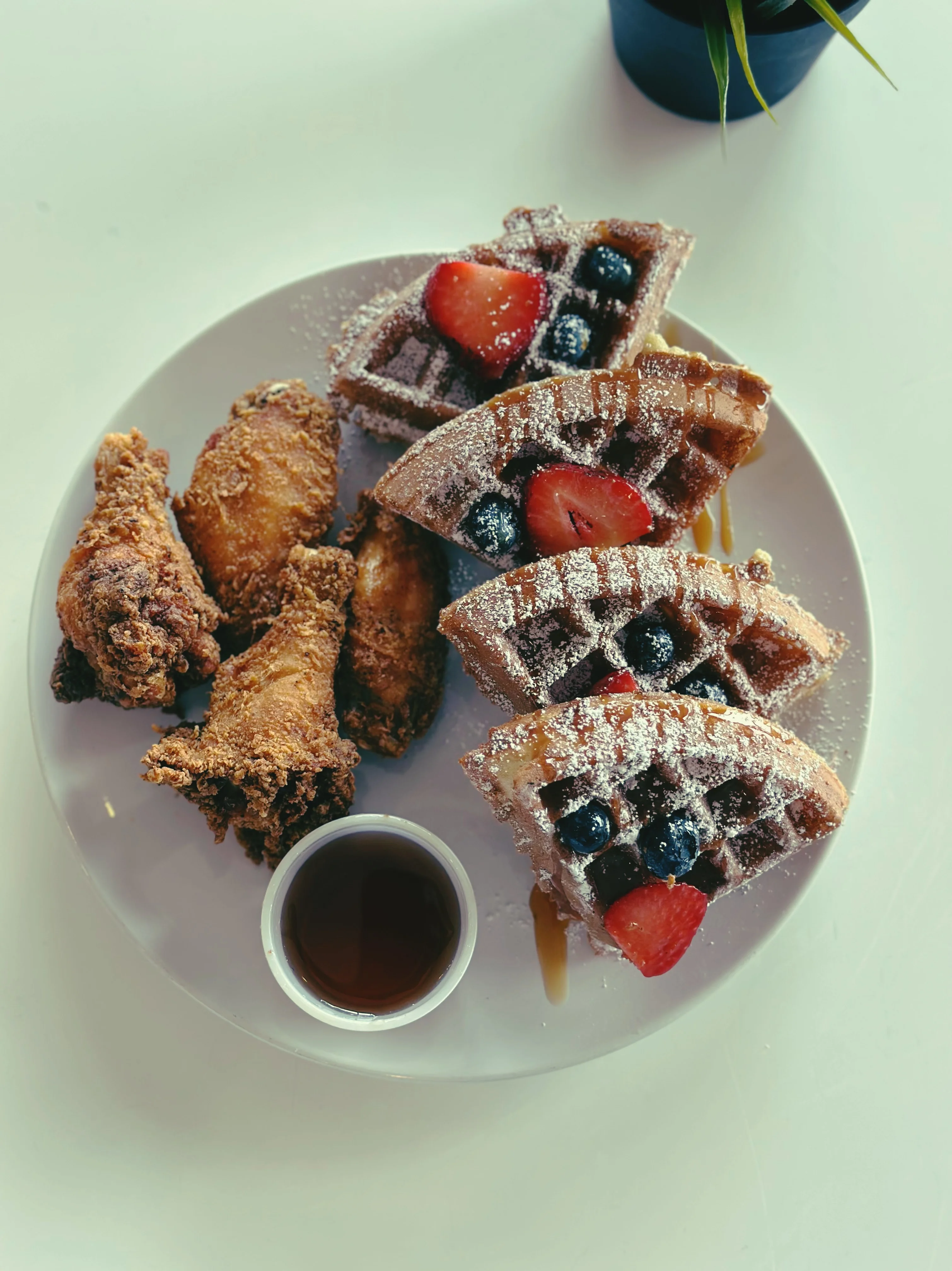Southern chicken and waffles with syrup and berries