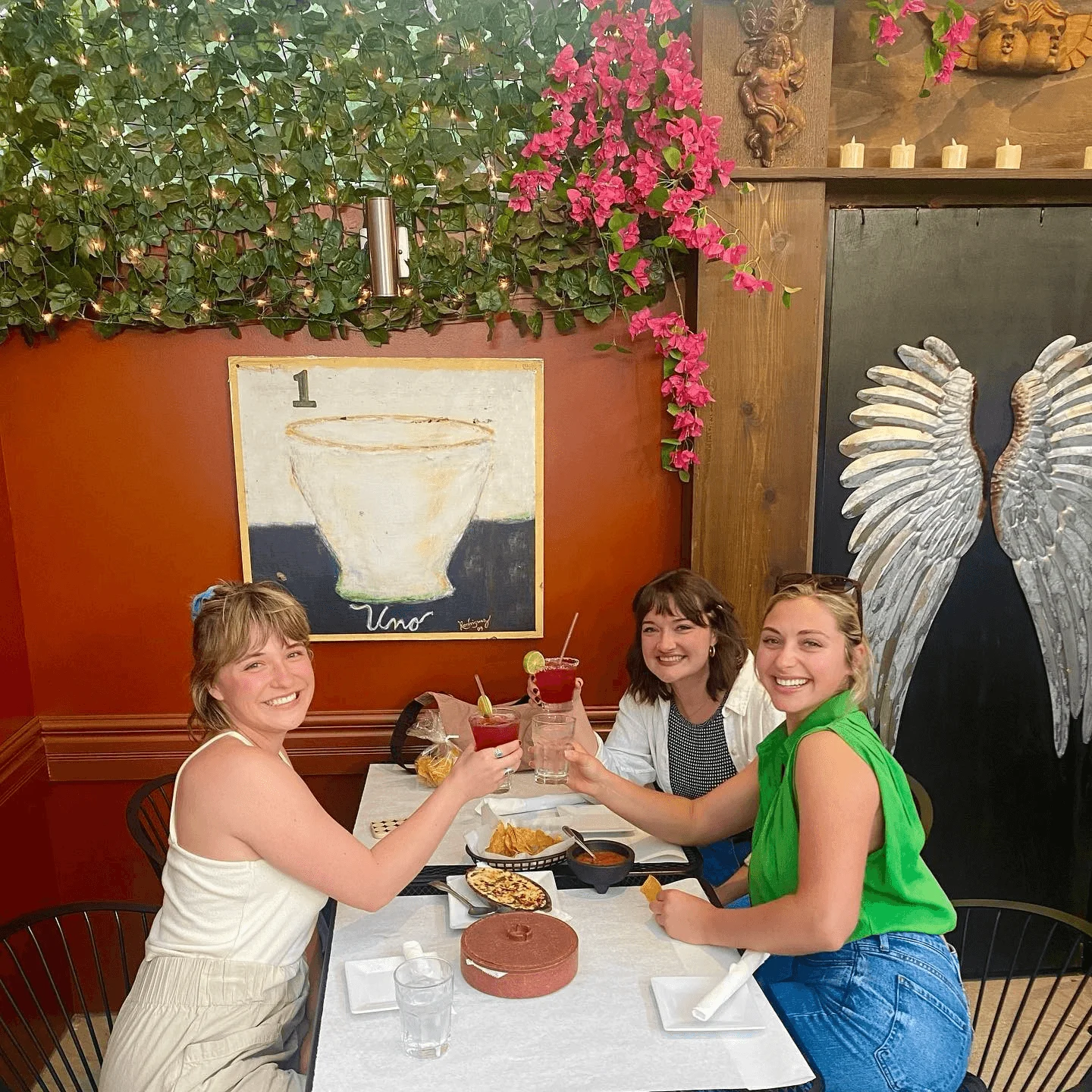 Friends enjoying drinks and snacks in a vibrant restaurant setting