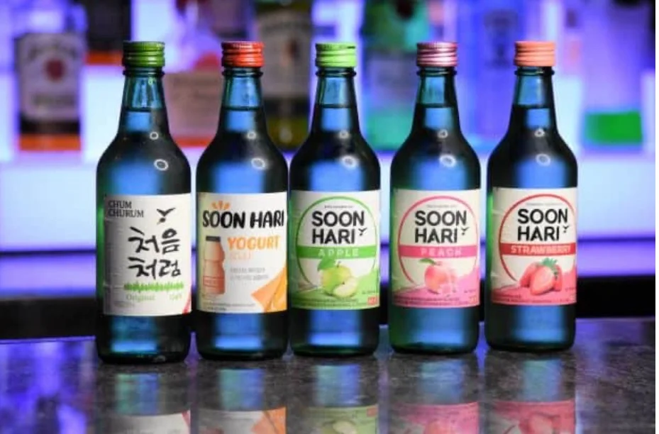 Variety of Korean flavored soju bottles on a bar counter