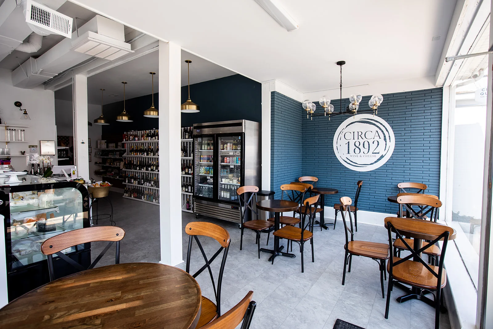 Cozy restaurant interior with wooden tables and wine display