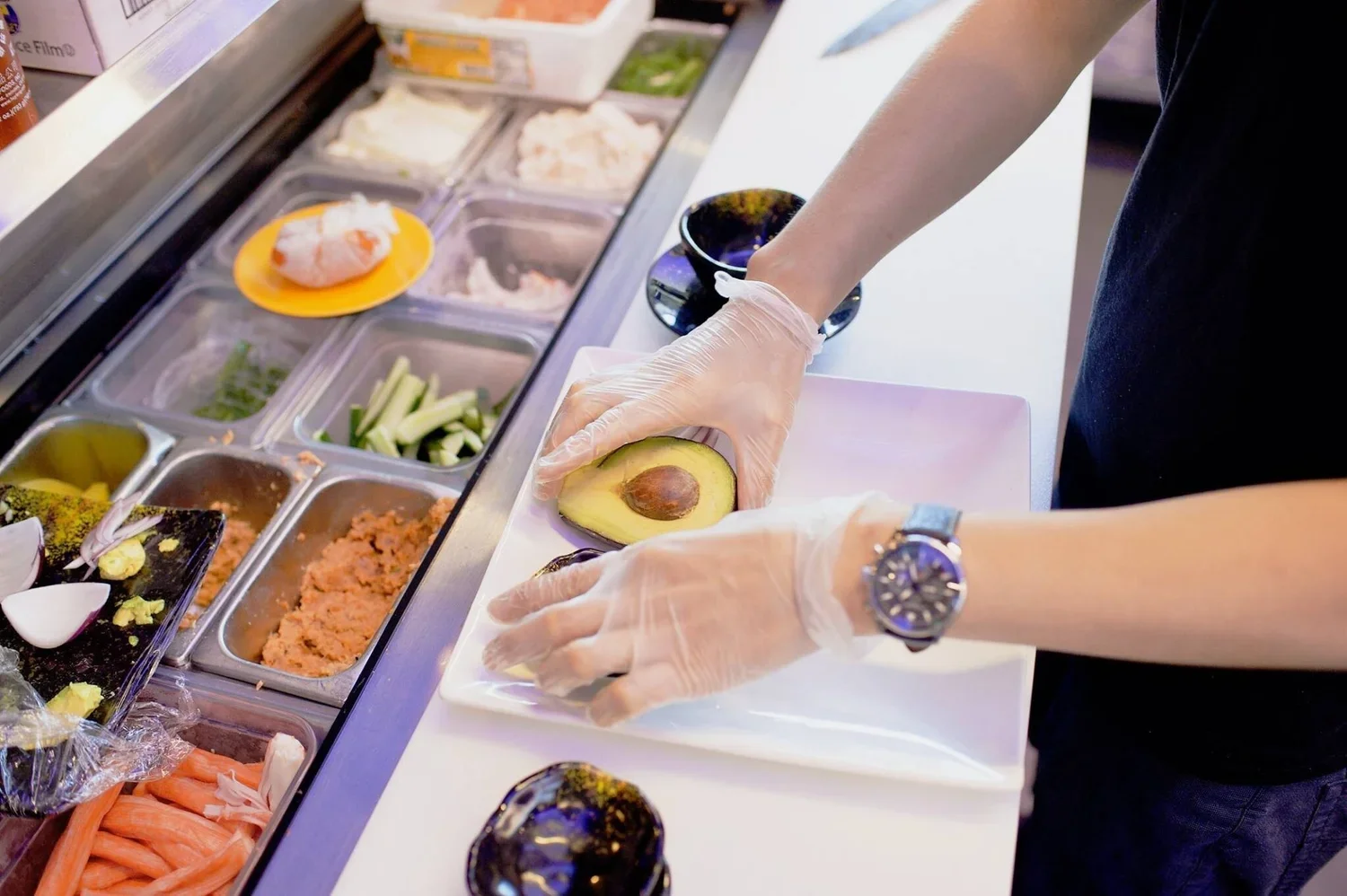 Preparing sushi with fresh avocado at a Japanese restaurant