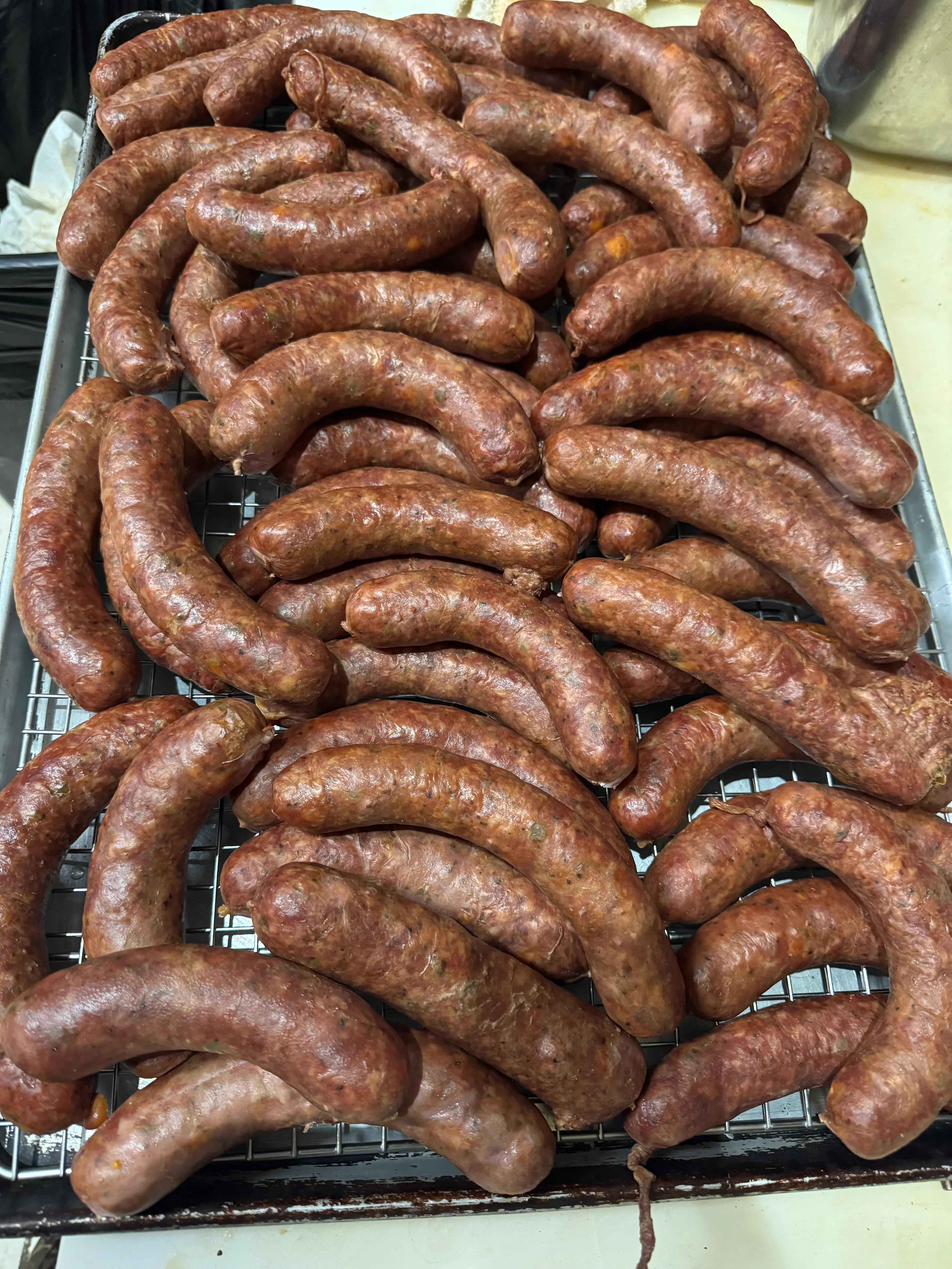 Homemade Italian sausages on a cooling rack