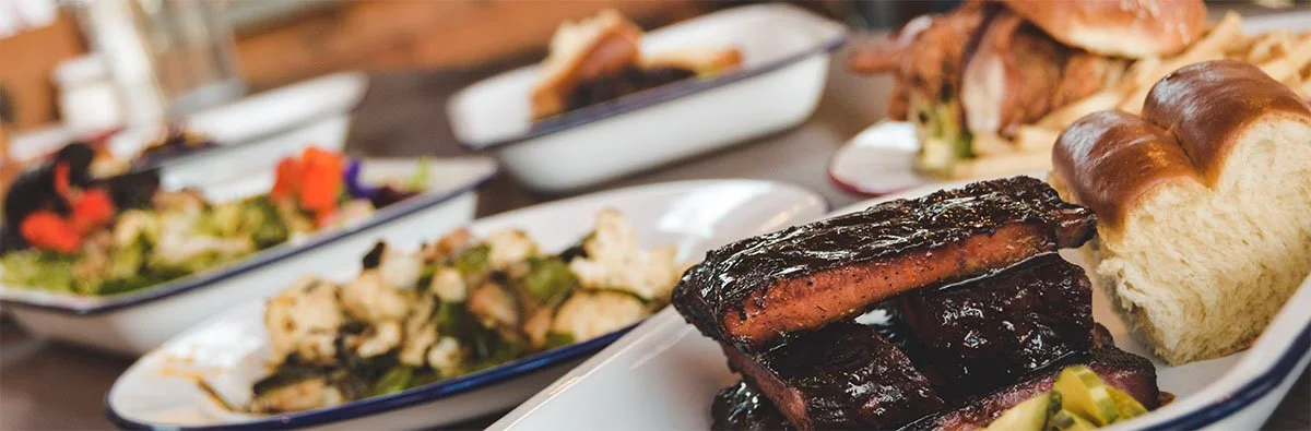 Barbecue ribs served with sides in a rustic dining setting