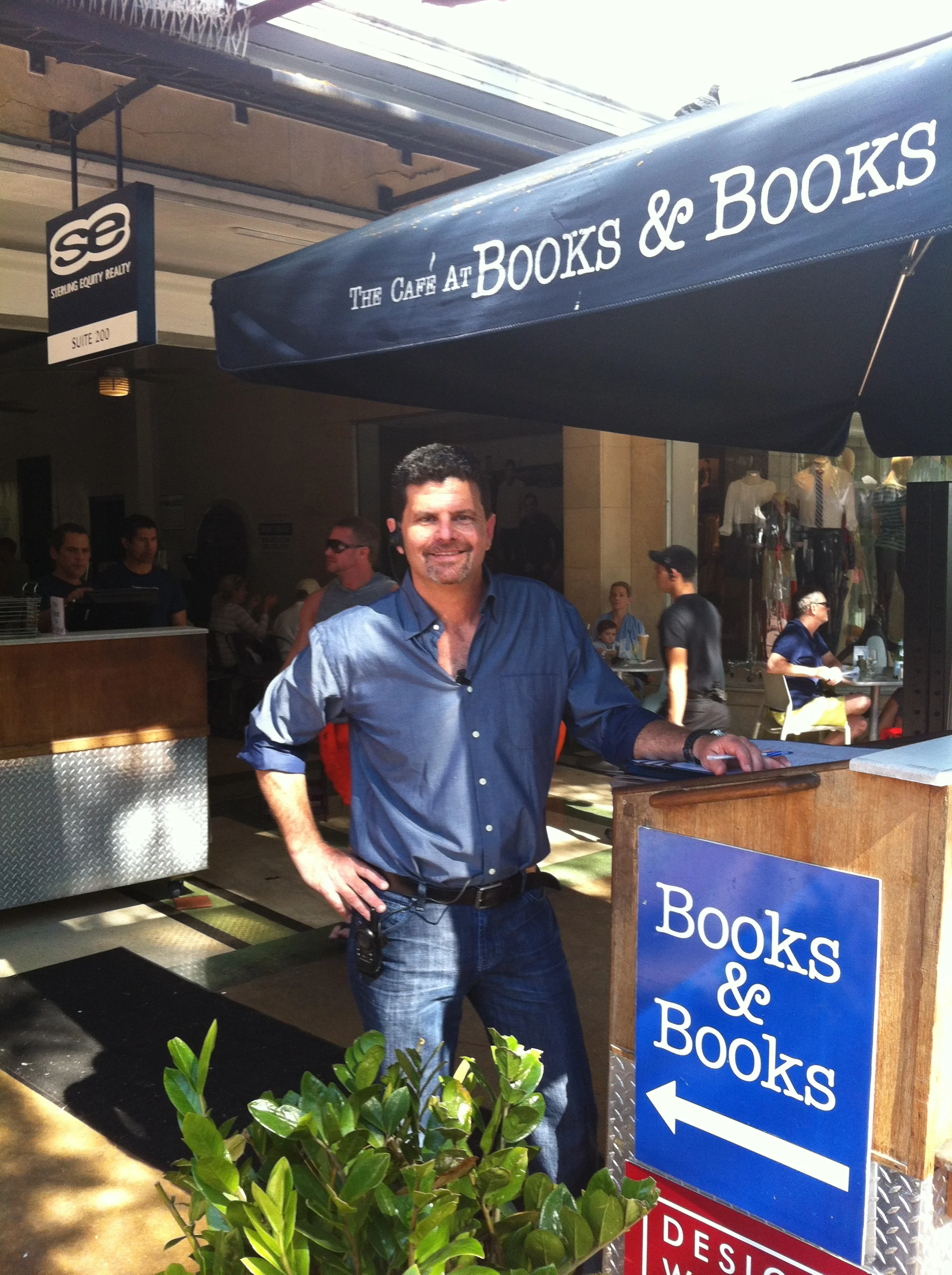 Cafe Books & Books storefront with outdoor dining and restaurant host