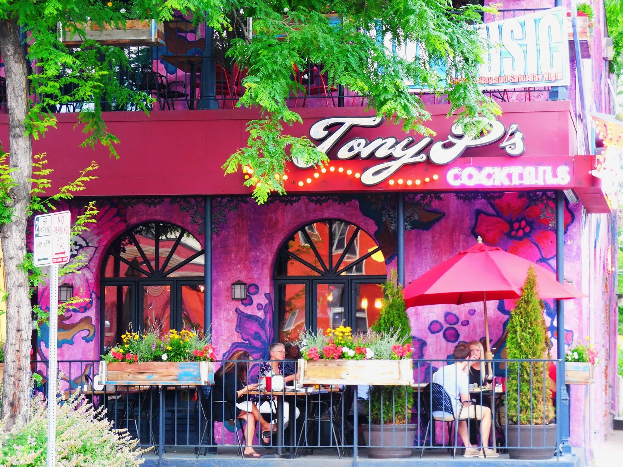 Vibrant restaurant exterior with outdoor seating and colorful mural