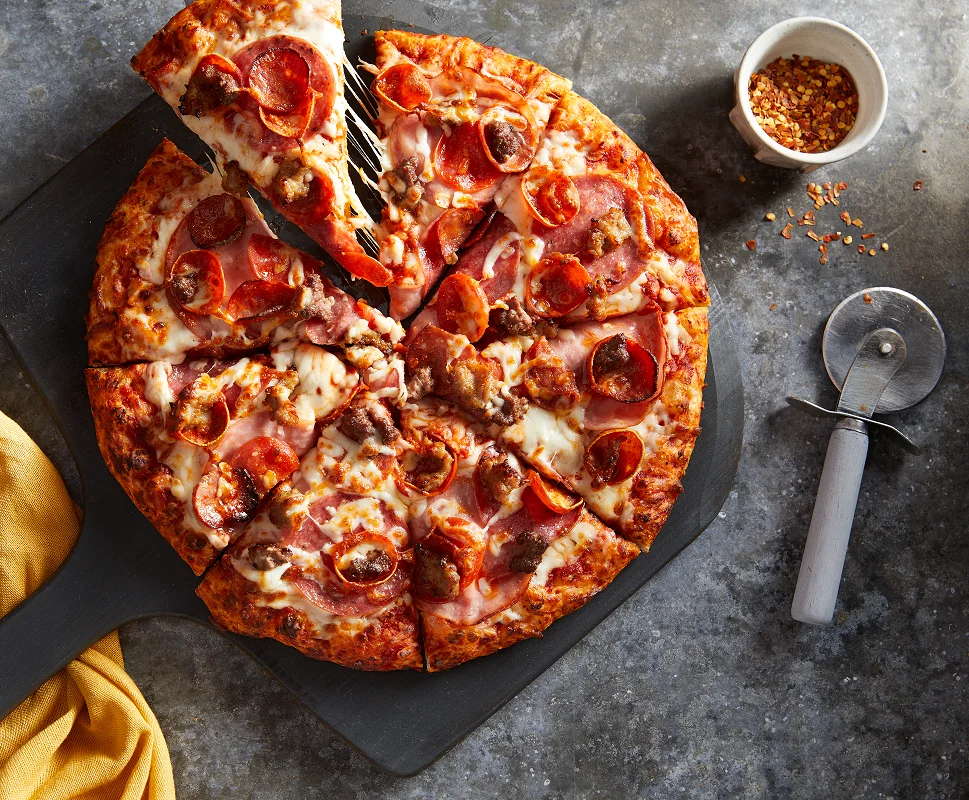 Pepperoni pizza on a wooden serving board