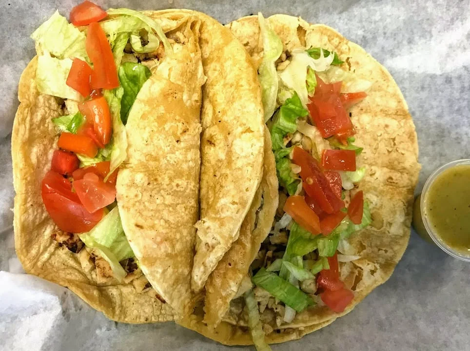 Two delicious chicken tacos with fresh toppings
