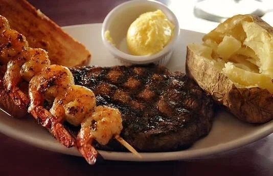 Grilled surf and turf platter with steak and shrimp skewers