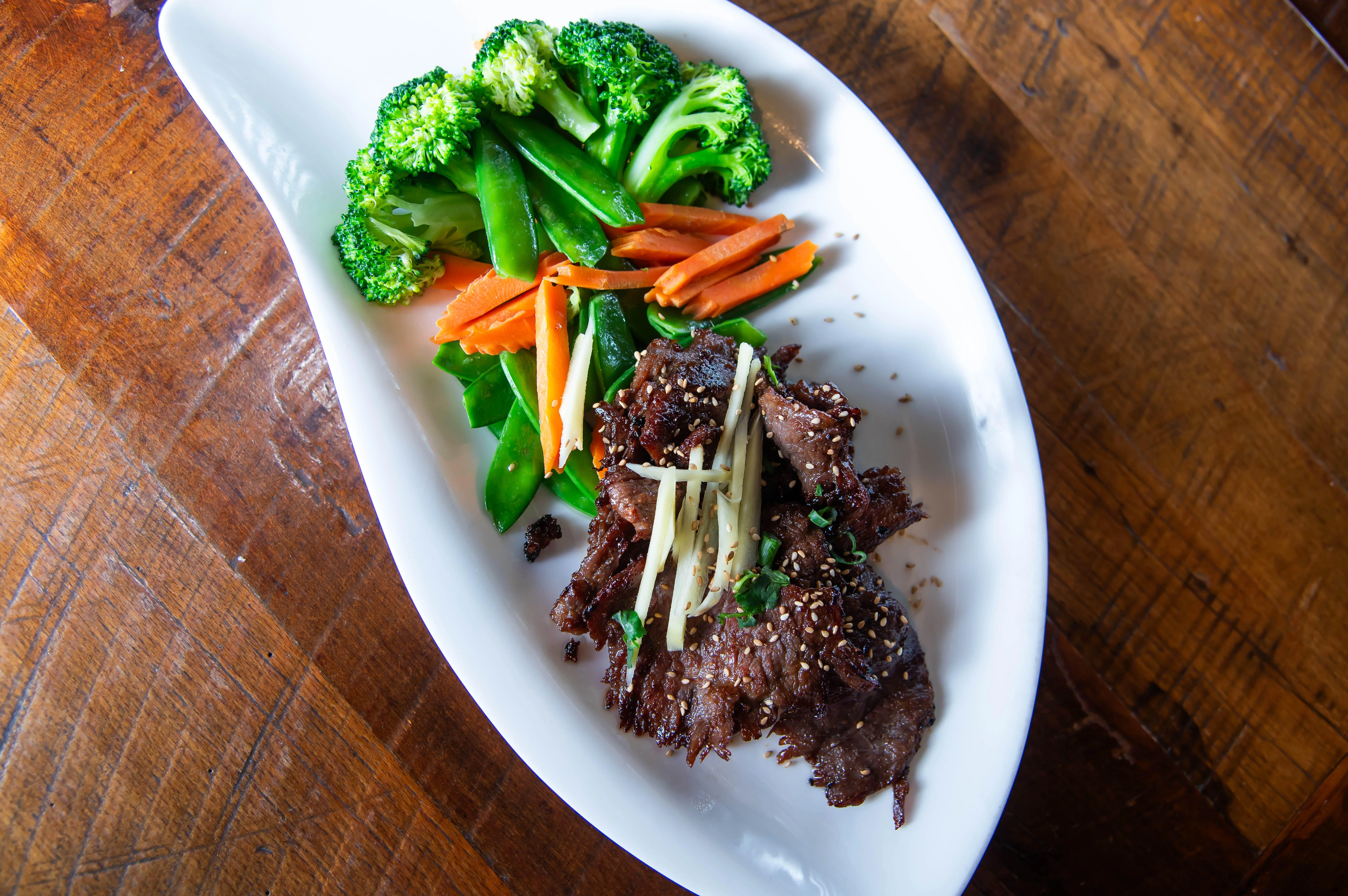 Korean bulgogi with mixed vegetables on a white plate