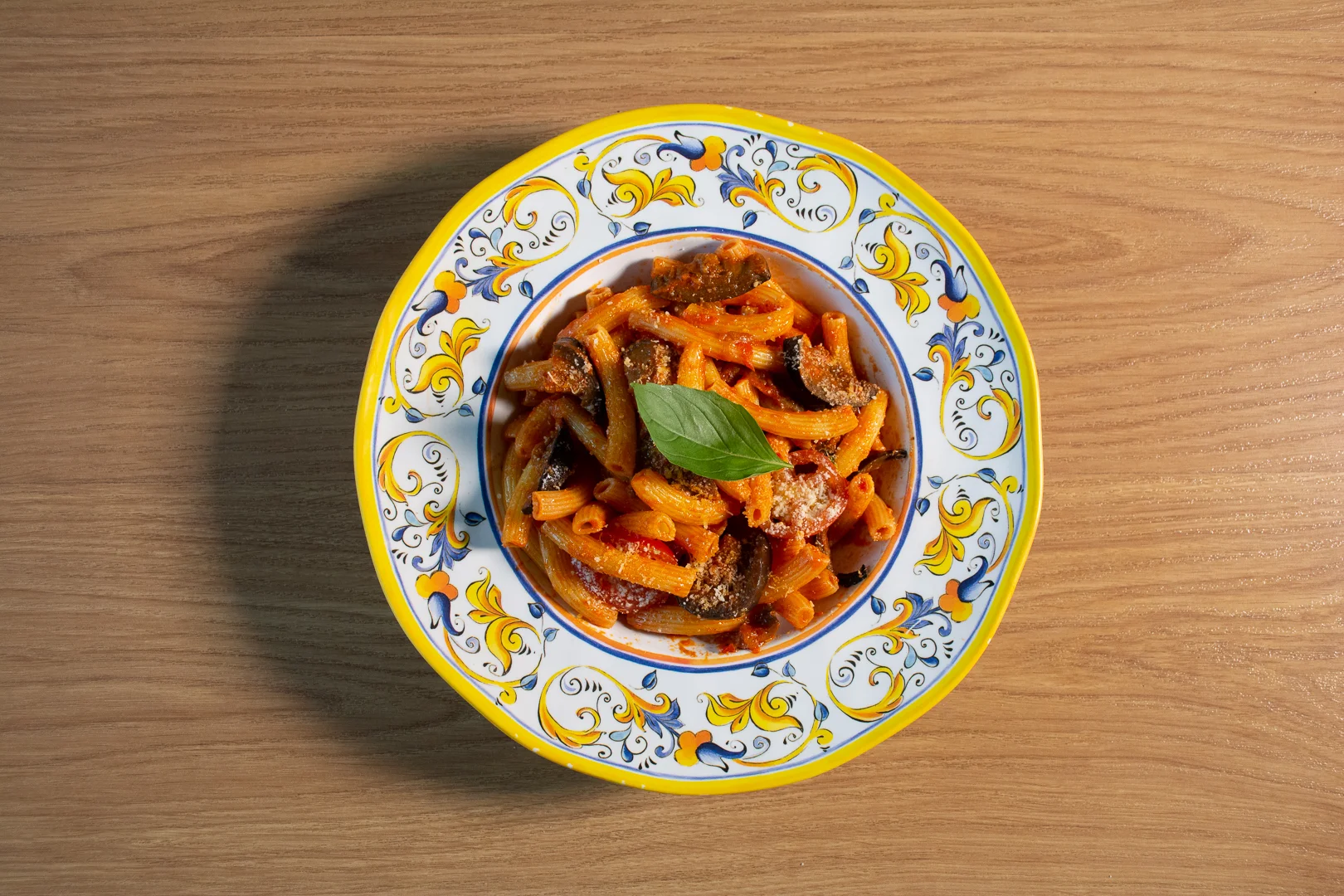Rustic Italian garden table with hanging dried chilies and preserved tomatoes
