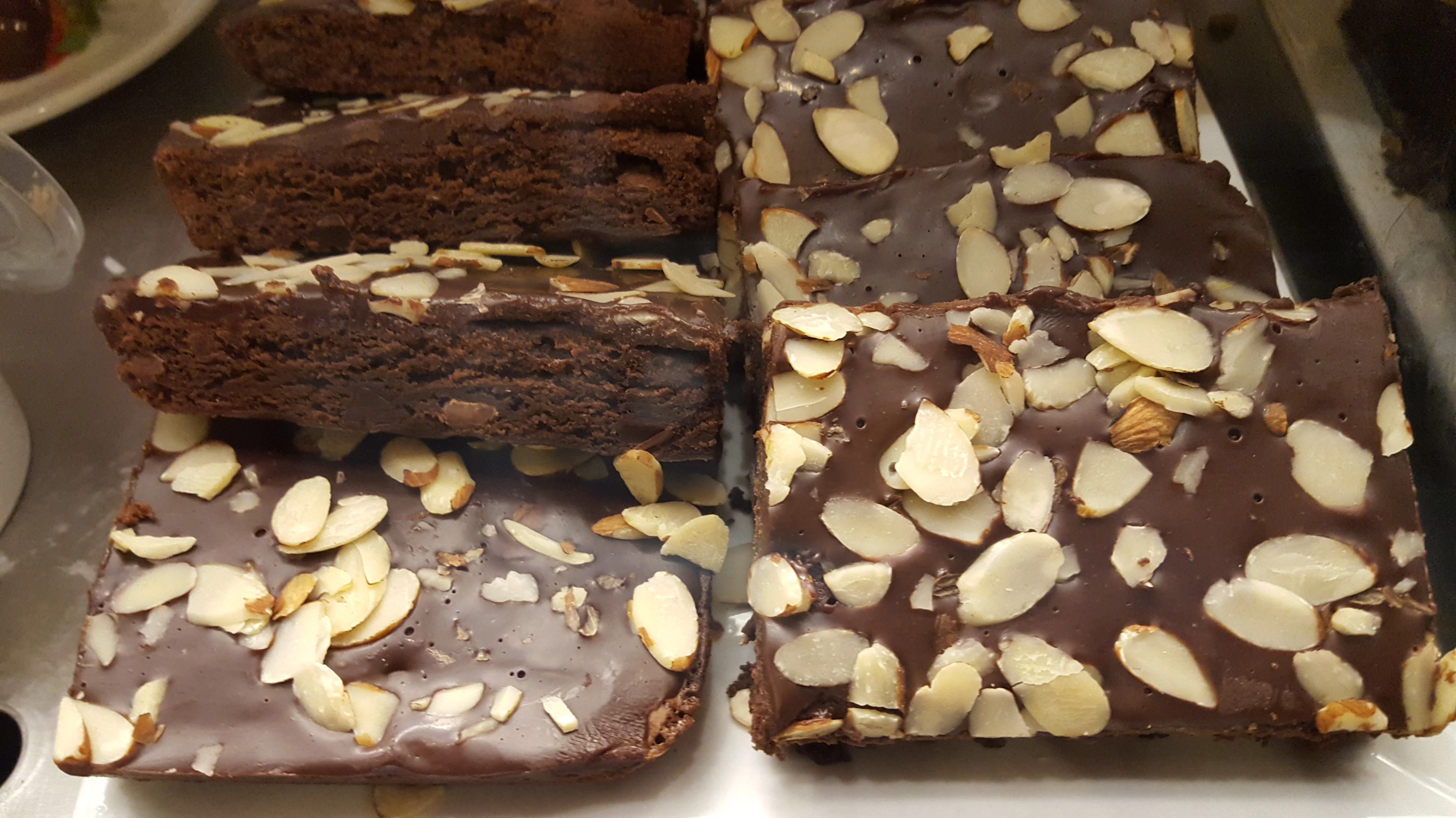 Decadent chocolate brownies topped with sliced almonds