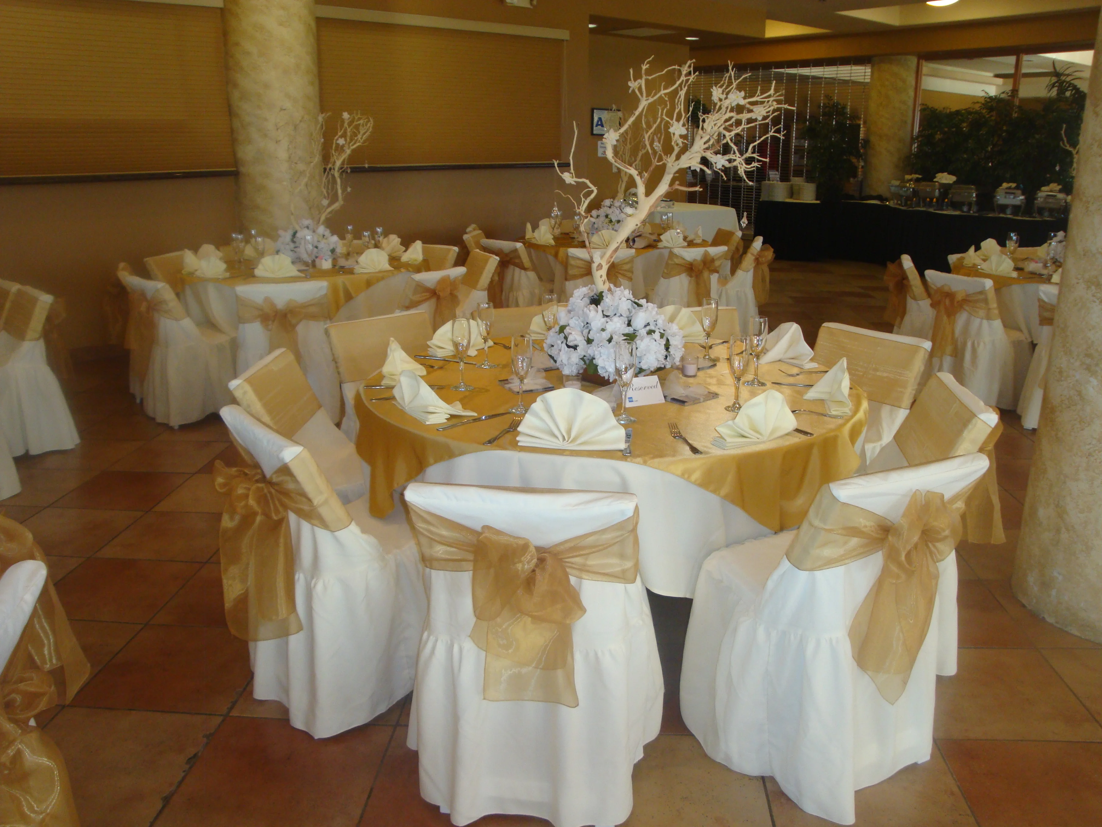 Elegant banquet setup with gold accents and floral centerpieces