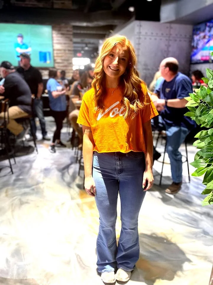 Smiling server in a vibrant restaurant setting