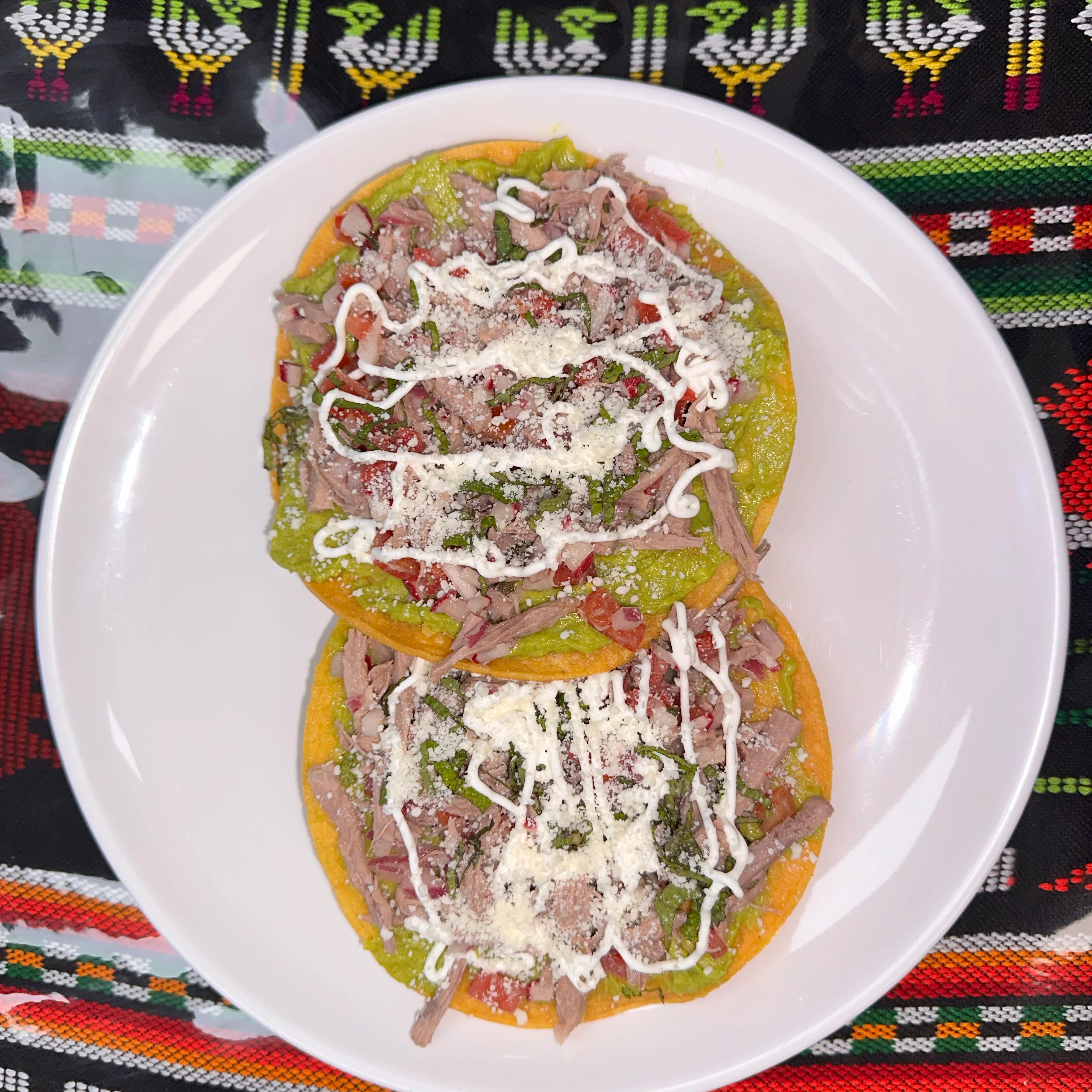 Delicious Mexican tostadas topped with shredded meat and fresh toppings