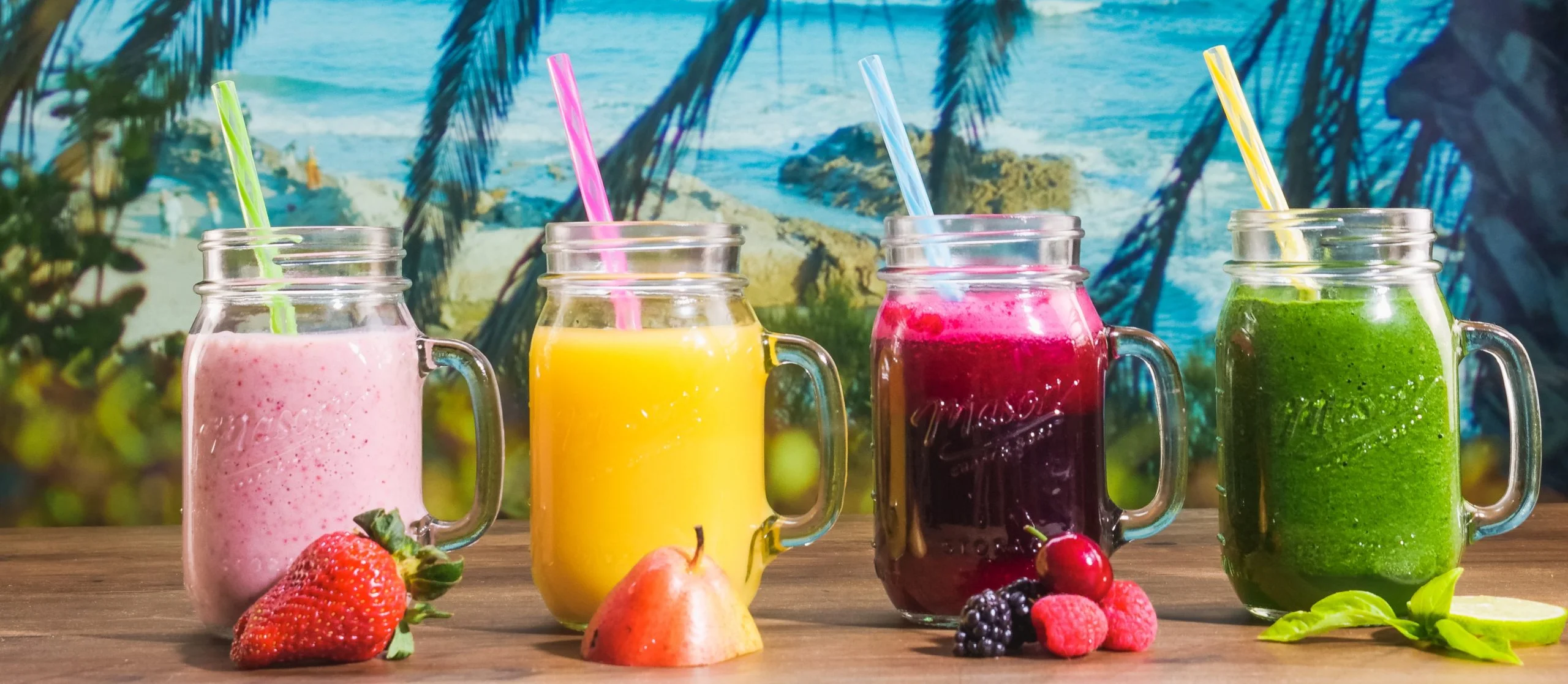 Colorful smoothie selection with tropical beach backdrop