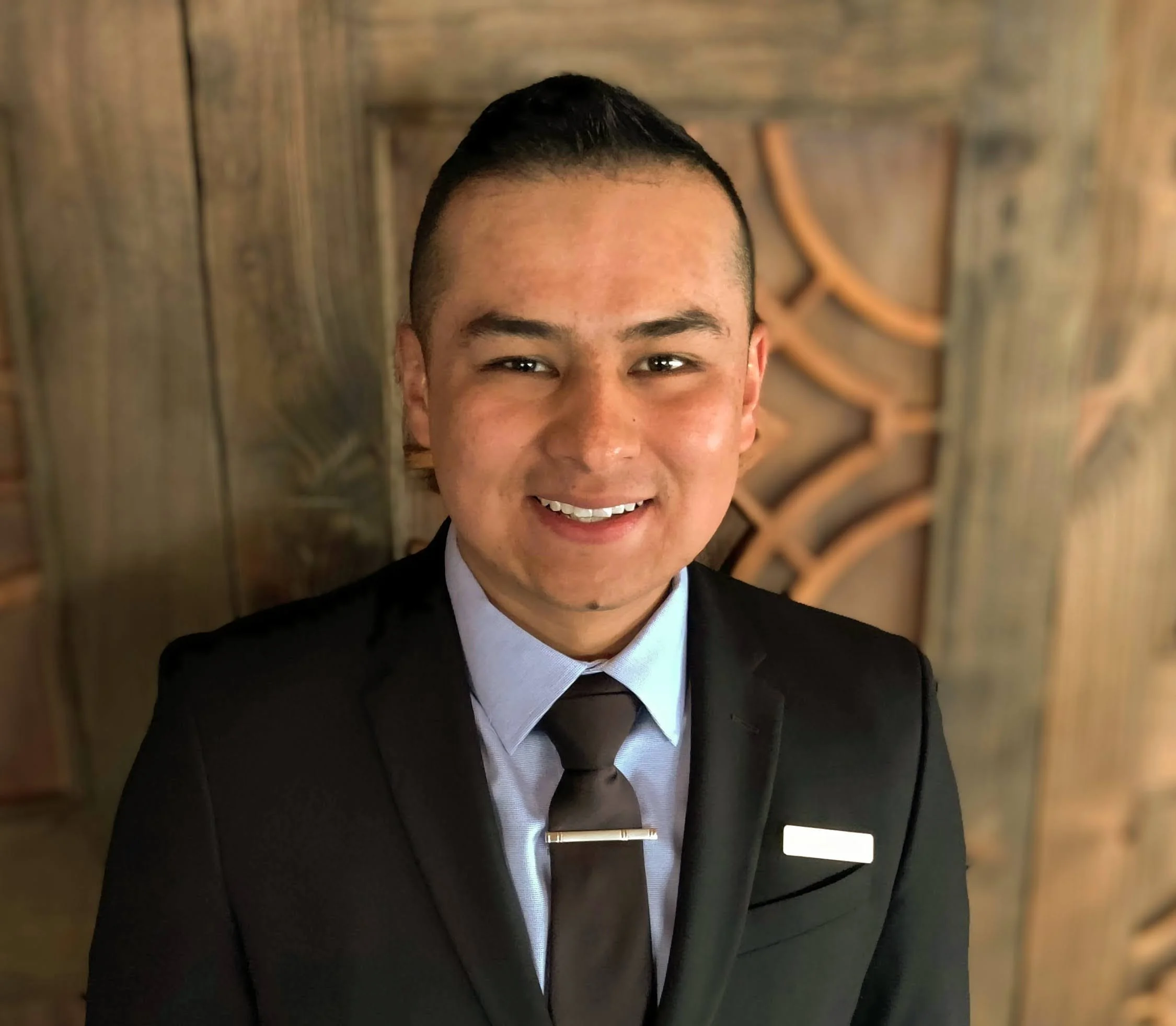 Professional man in a suit smiling in a restaurant setting