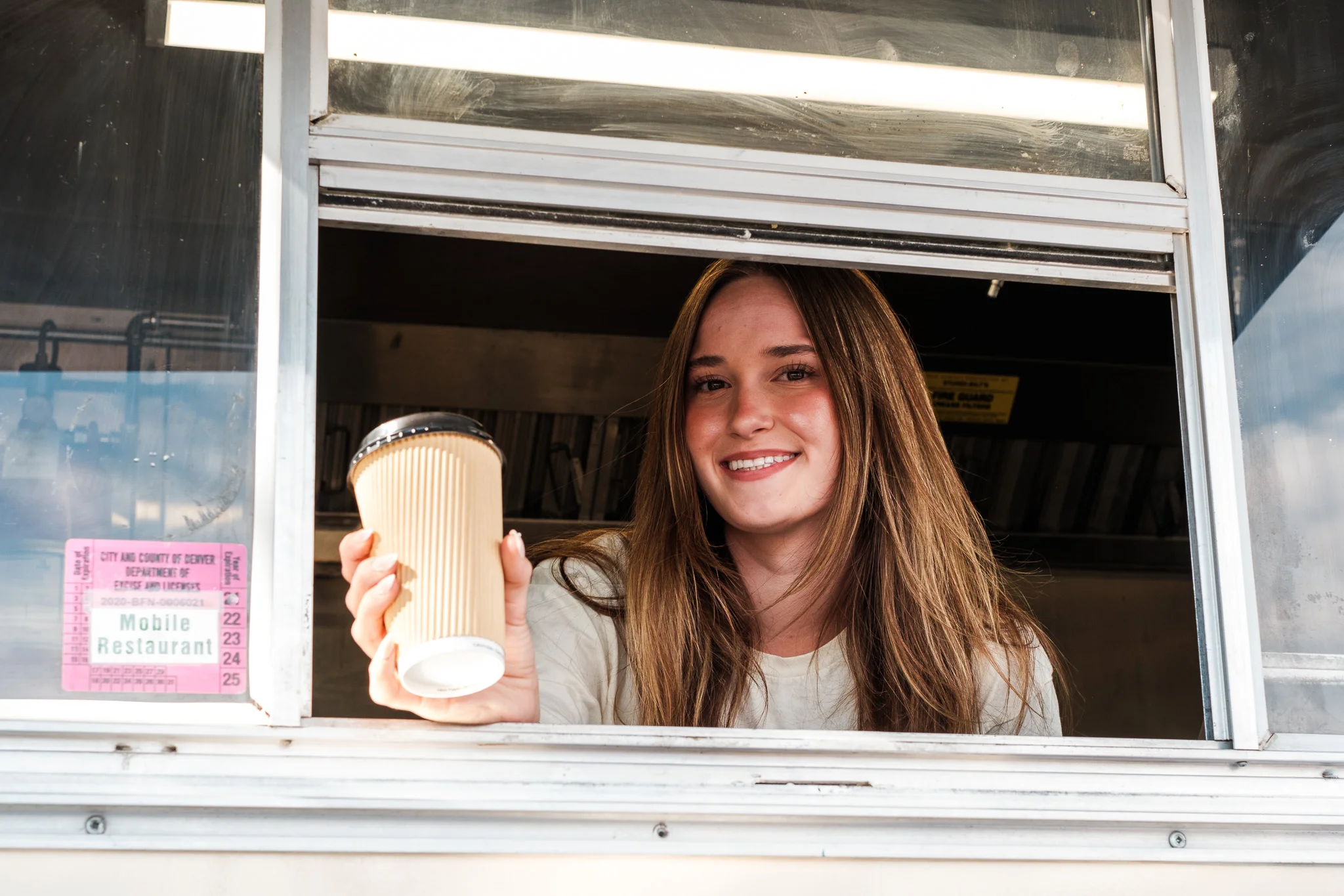 Food truck operators smiling in their vehicle