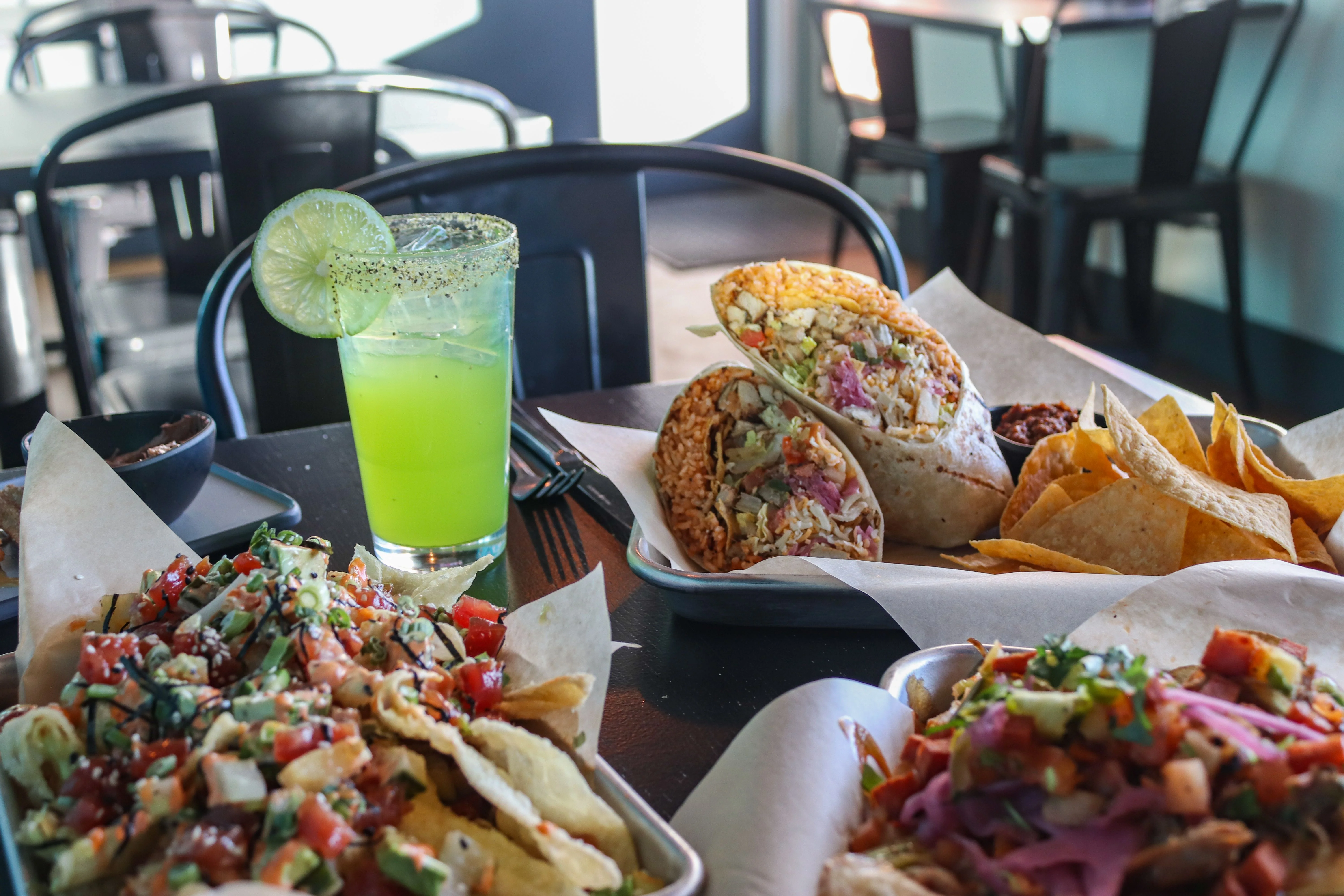 Colorful Mexican burritos with nachos and a refreshing cocktail