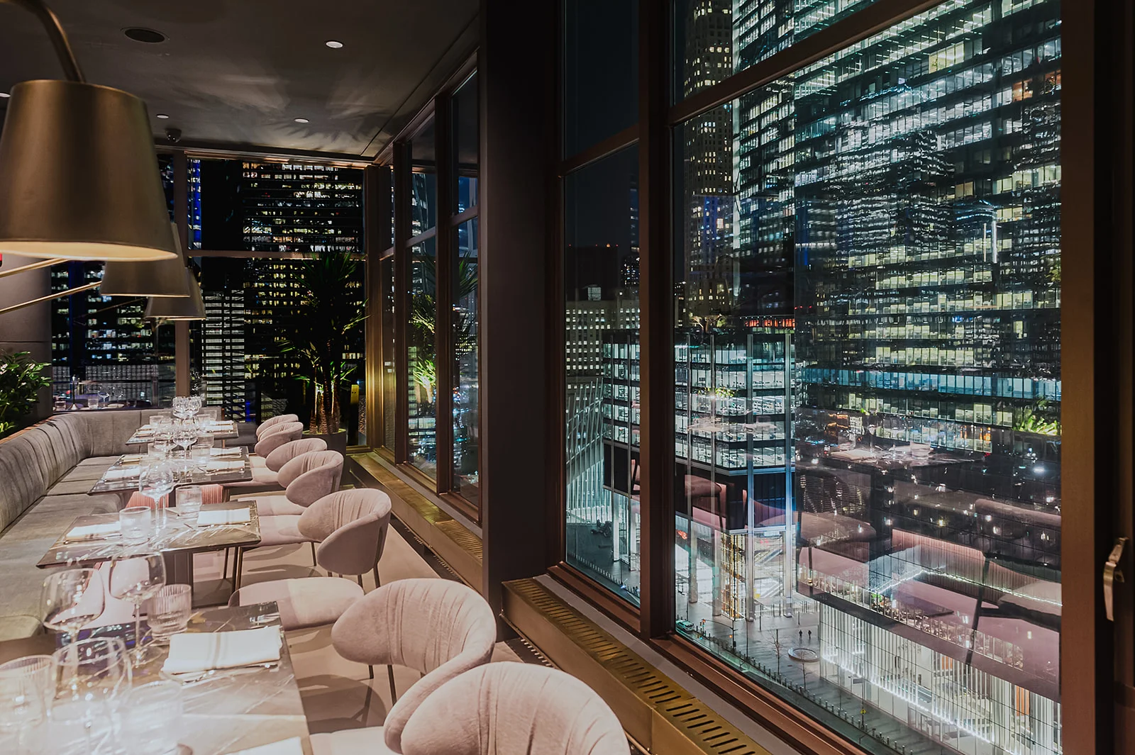 Elegant restaurant interior with city skyline views at night