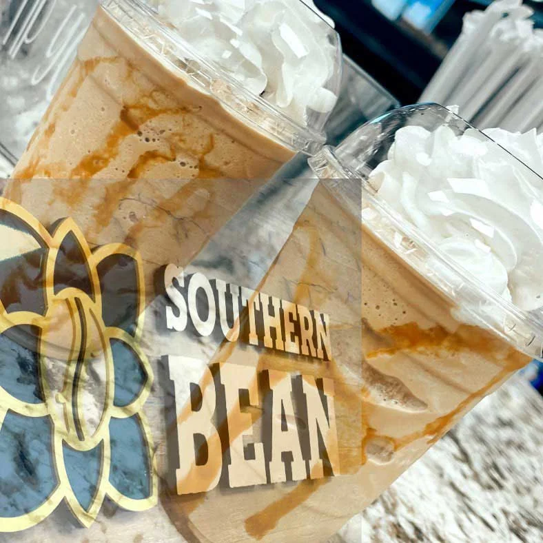 Iced coffee drink topped with whipped cream and caramel drizzle