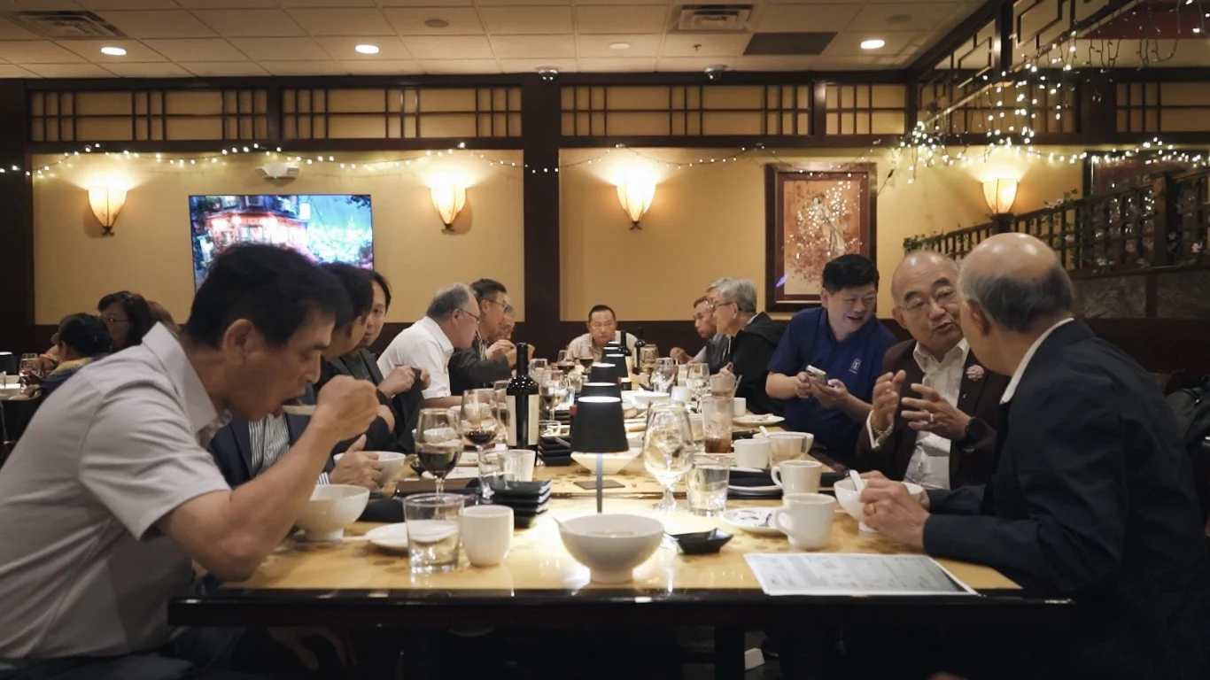 Group of friends sharing a private dinner at a long table at Mahzu East Windsor