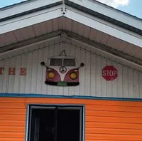 Colorful restaurant exterior with vintage car decor