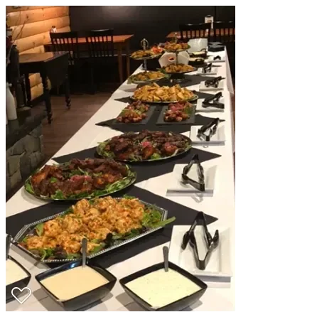 Assorted platters of barbecue meats in a rustic dining setting
