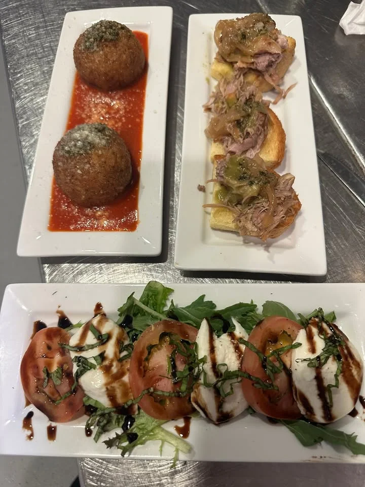 Italian antipasto platter with arancini and caprese salad