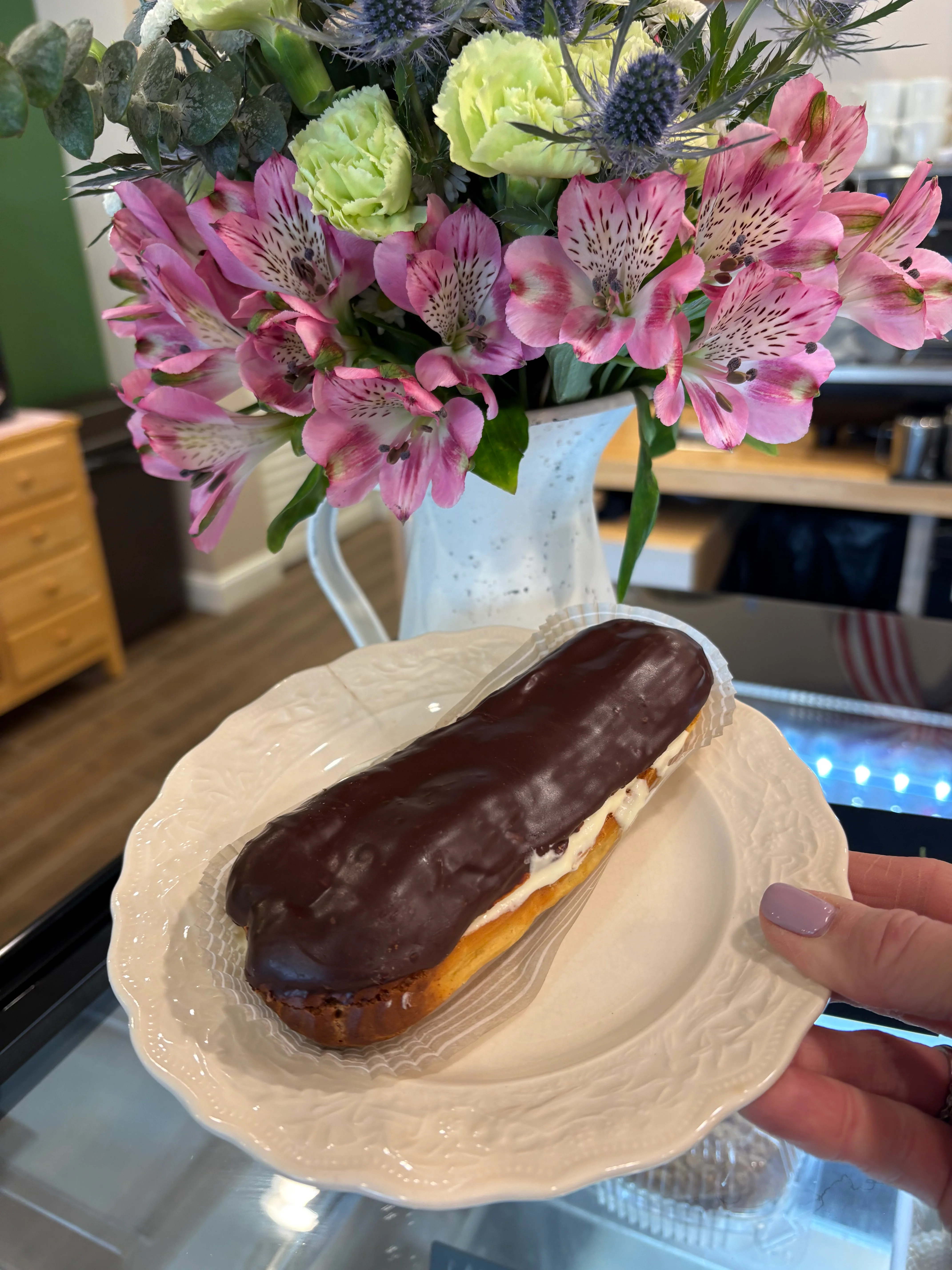Chocolate eclair on a decorative plate