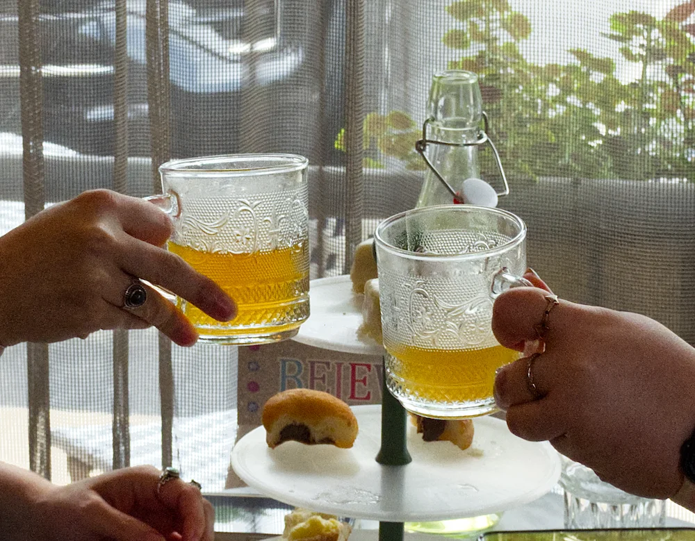Cheers with refreshing herbal tea in vintage glass mugs