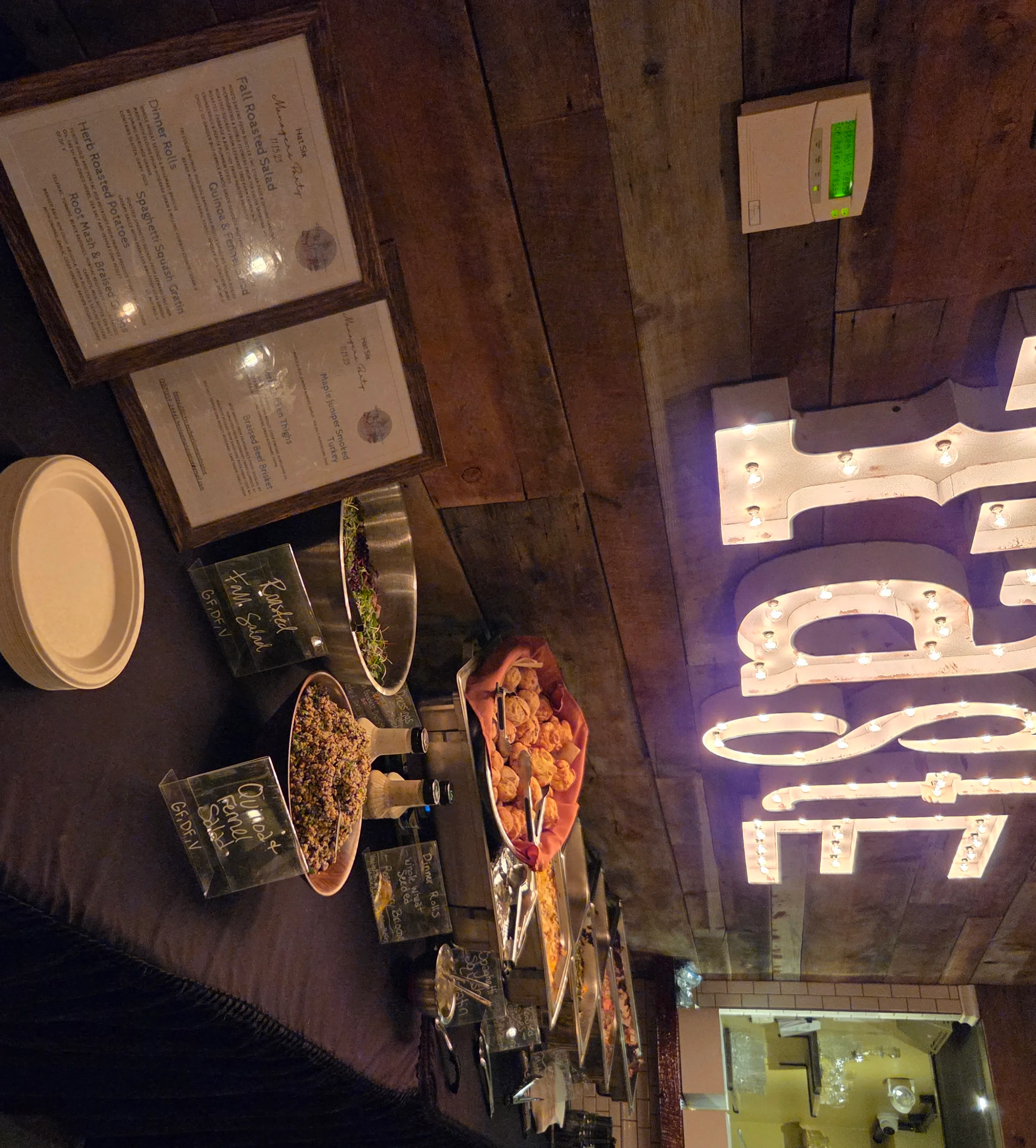 Cozy restaurant buffet setup with illuminated 'Taste' sign