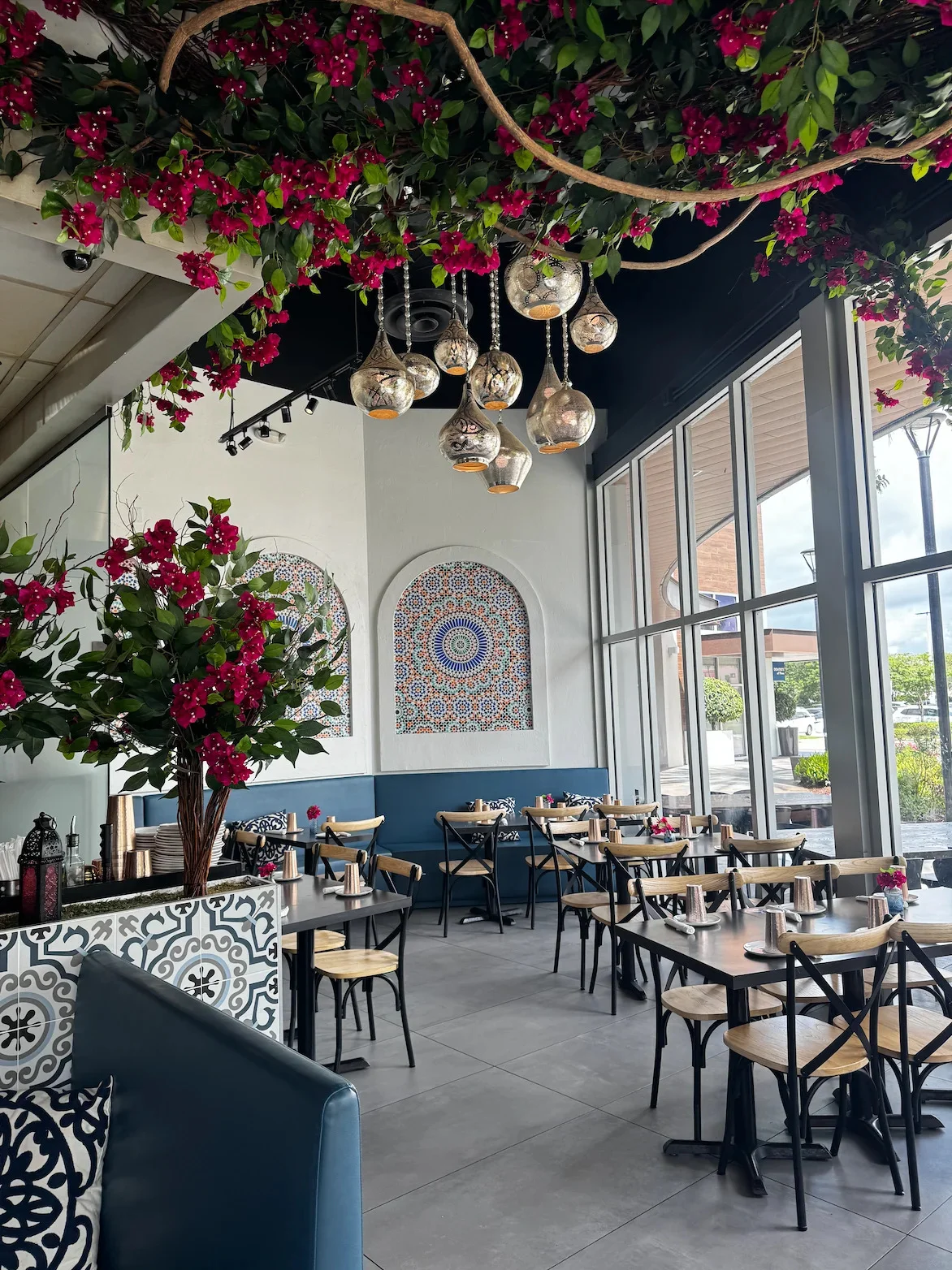 Sufrat Grill Pembroke Pines location with floral décor, mosaic accents, and hanging lanterns.