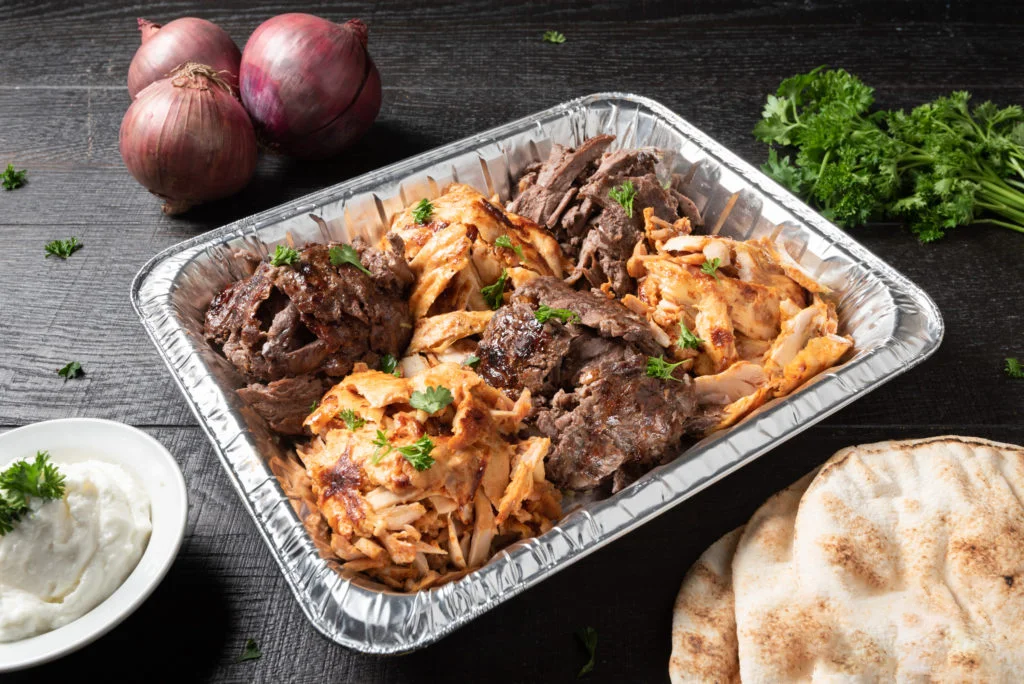 Mediterranean mixed grill platter with meats and pita bread
