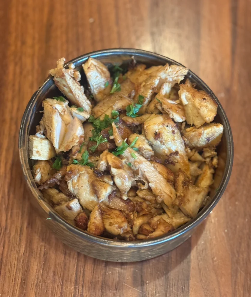 A bowl of chicken shawarma sides at Sufrat Grill.