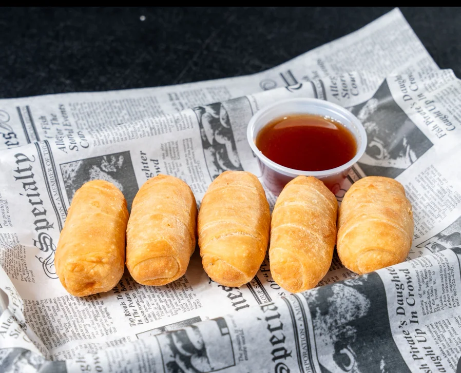 Crispy fried egg rolls served with dipping sauce