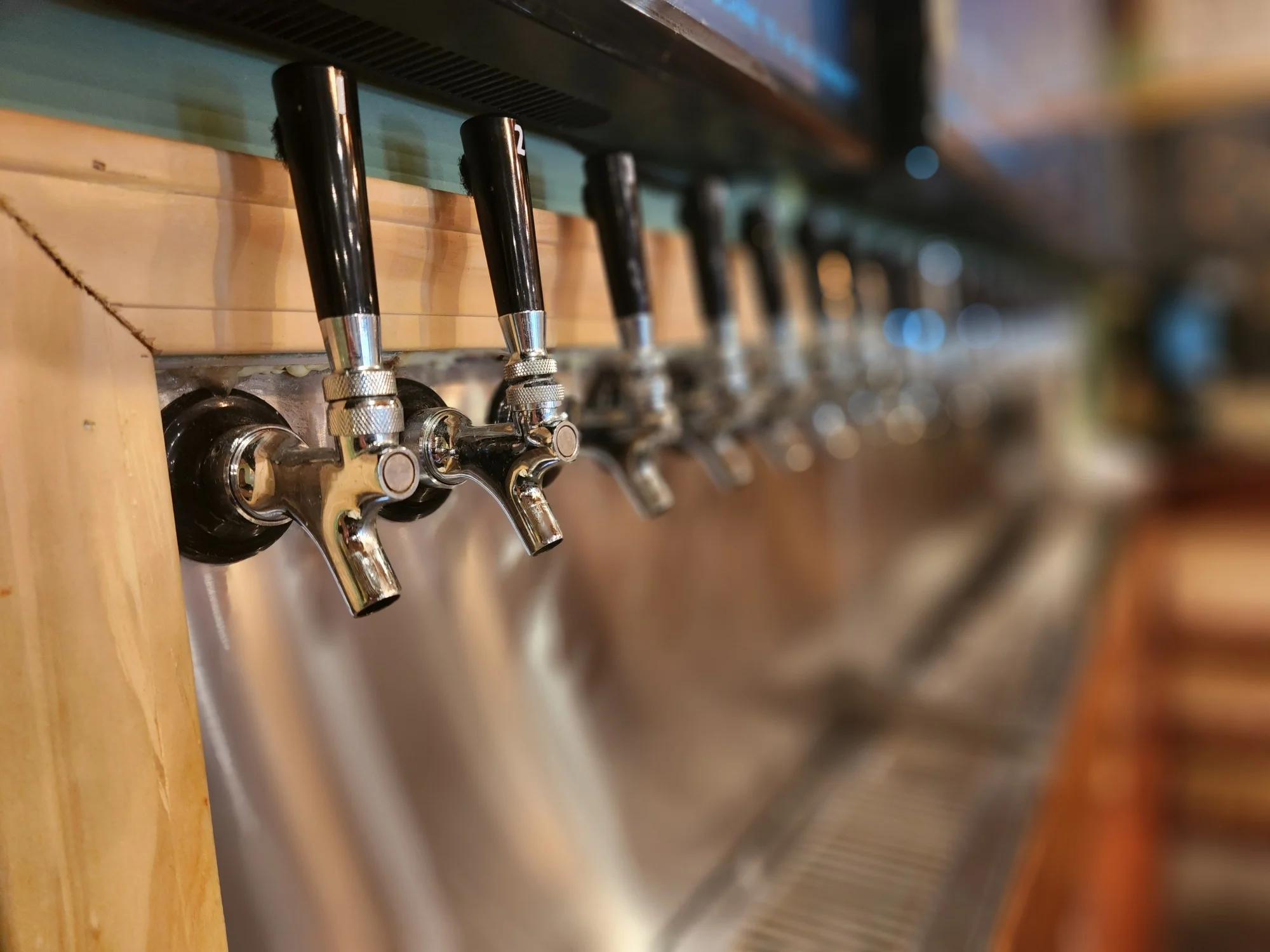 Row of beer taps at a modern bar