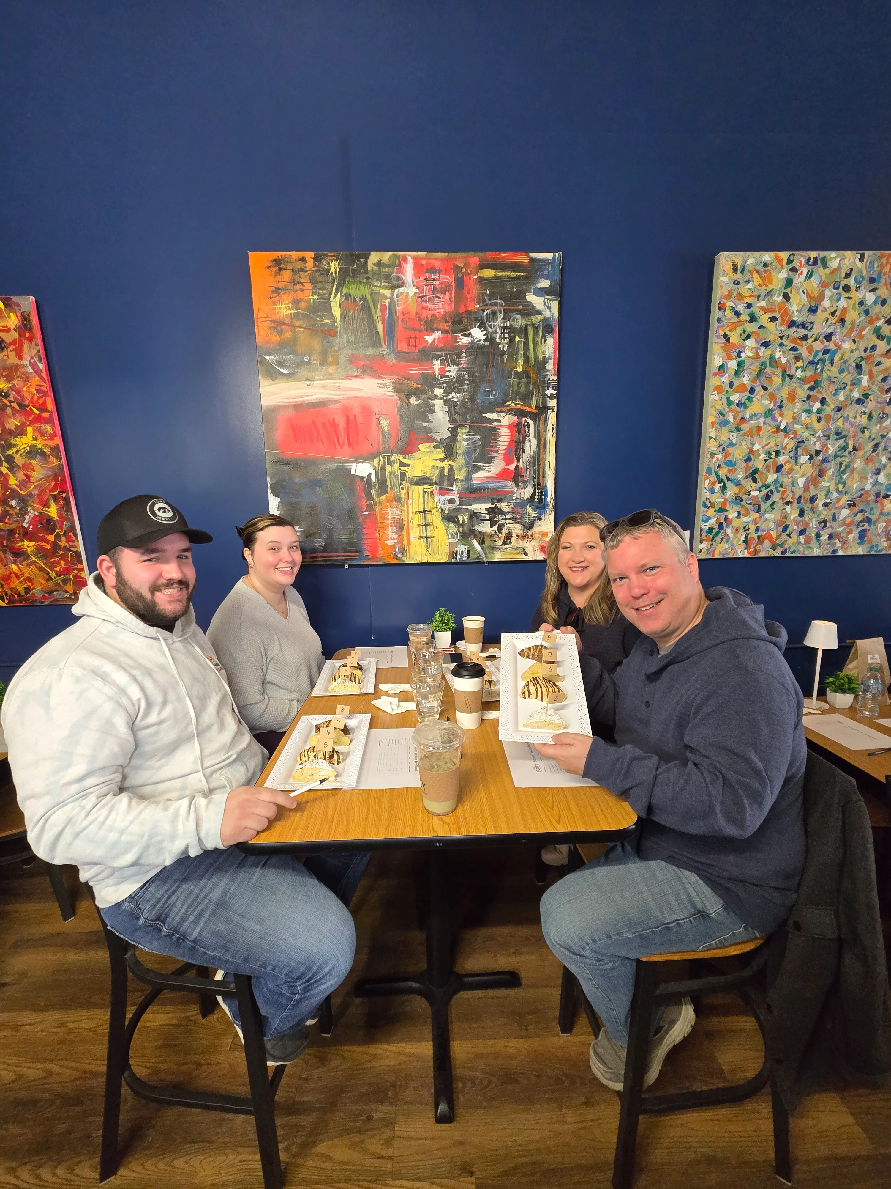 Two couples enjoying treats together at a table