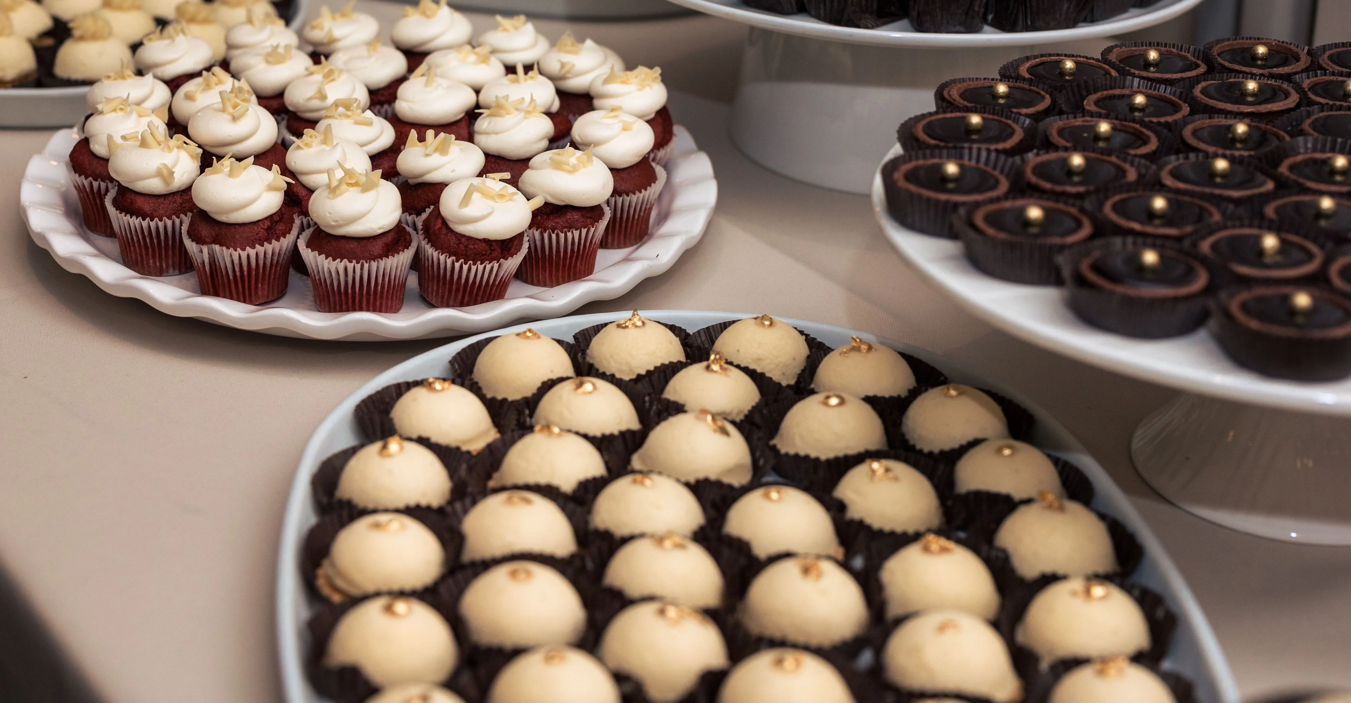 Assorted gourmet cupcakes and confections on display