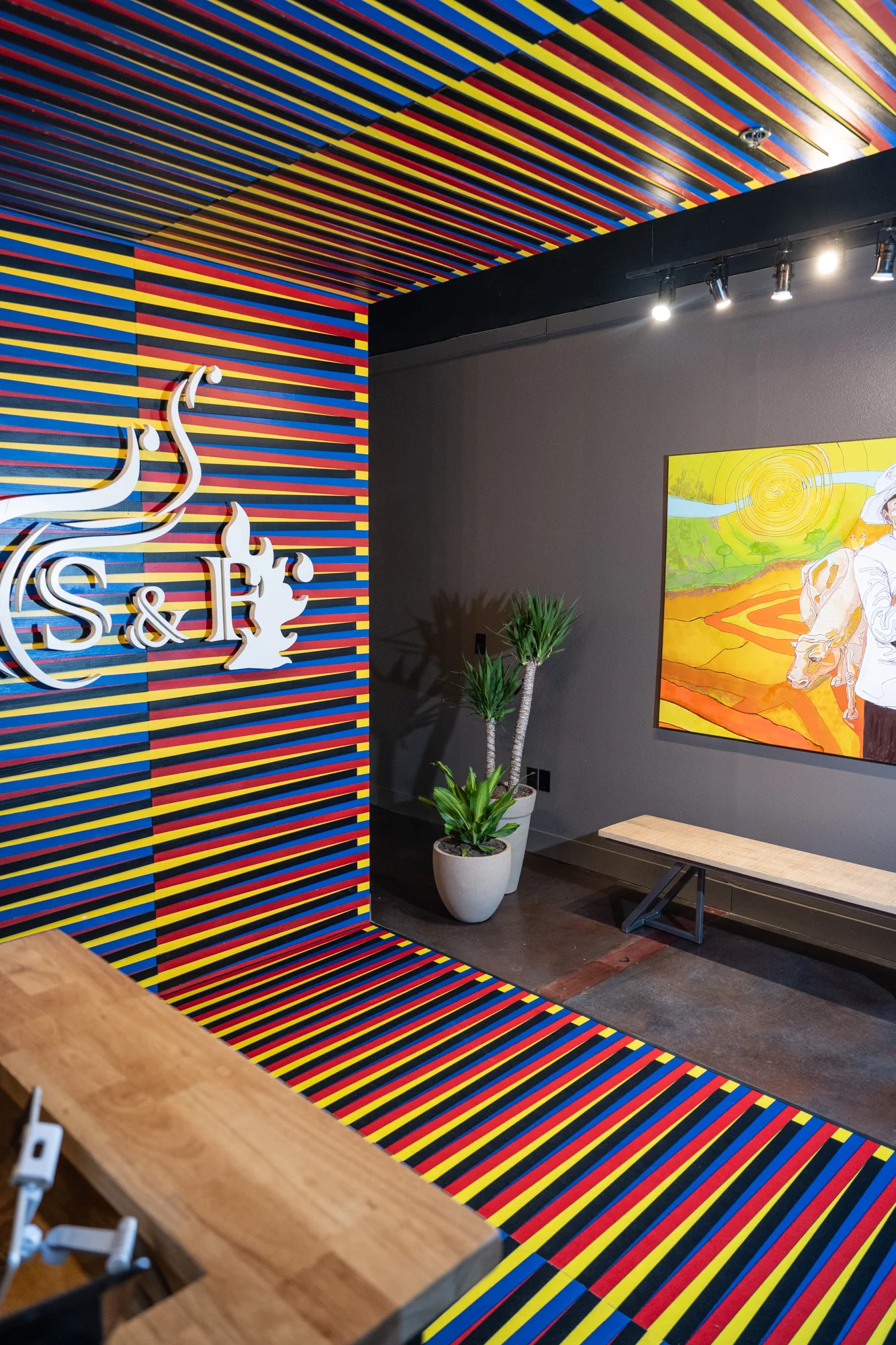 Vibrant restaurant interior with colorful striped walls and artwork