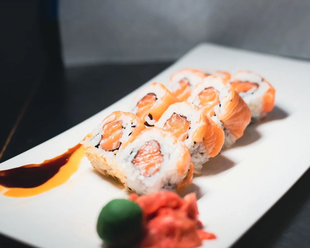 Japanese salmon sushi rolls on a white plate