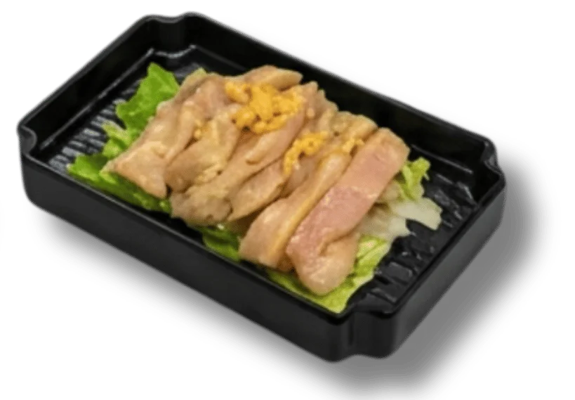 Grilled chicken slices on lettuce in a black takeout container.
