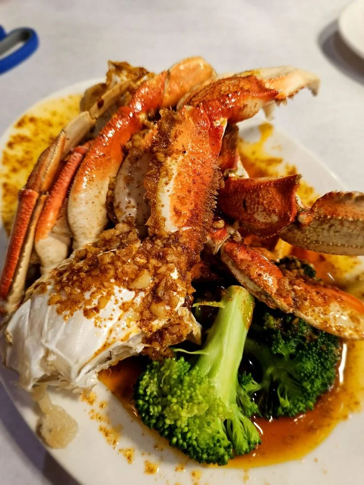 Savory garlic crab legs served with broccoli