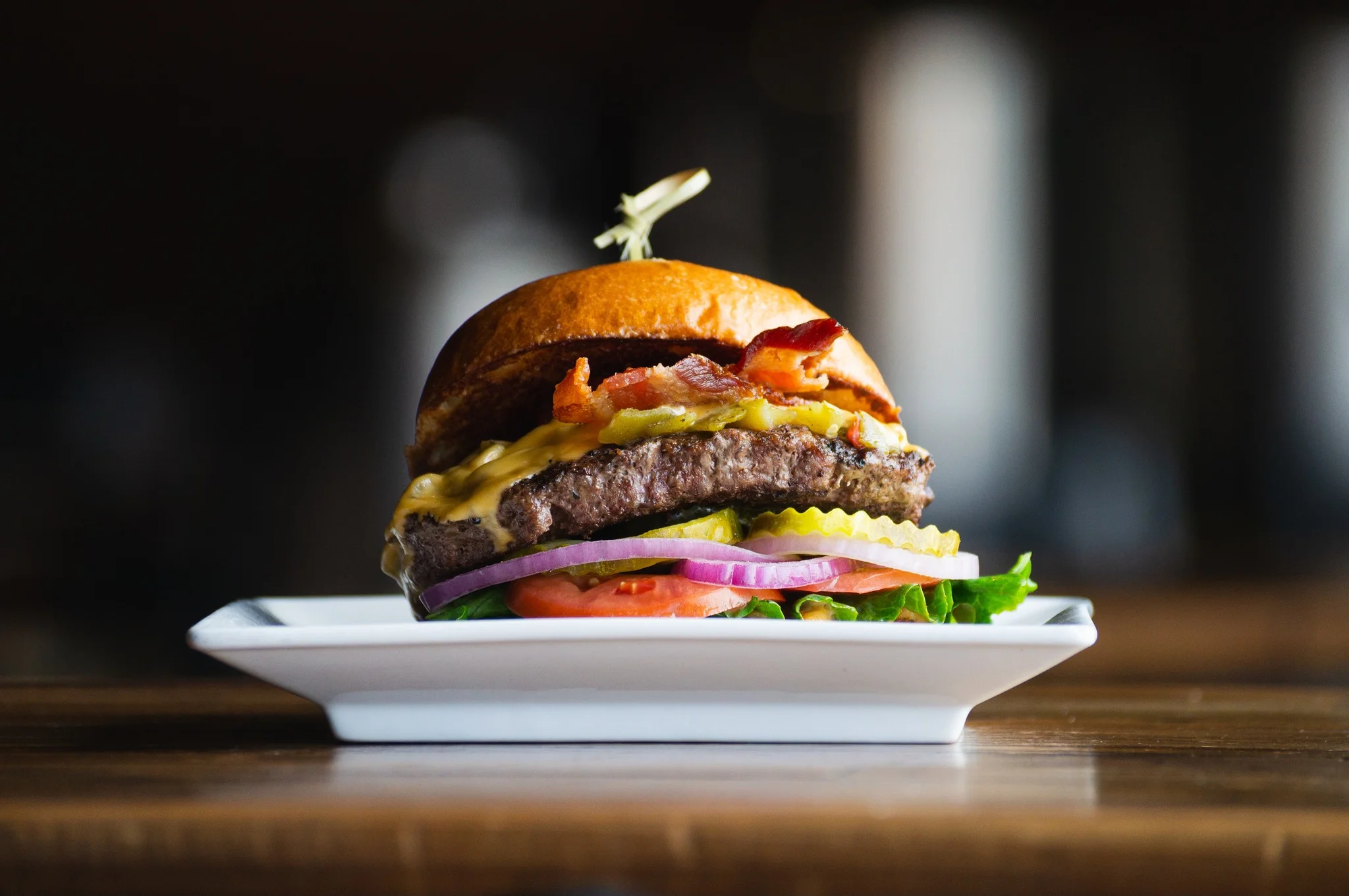 Juicy American cheeseburger with bacon and fresh toppings