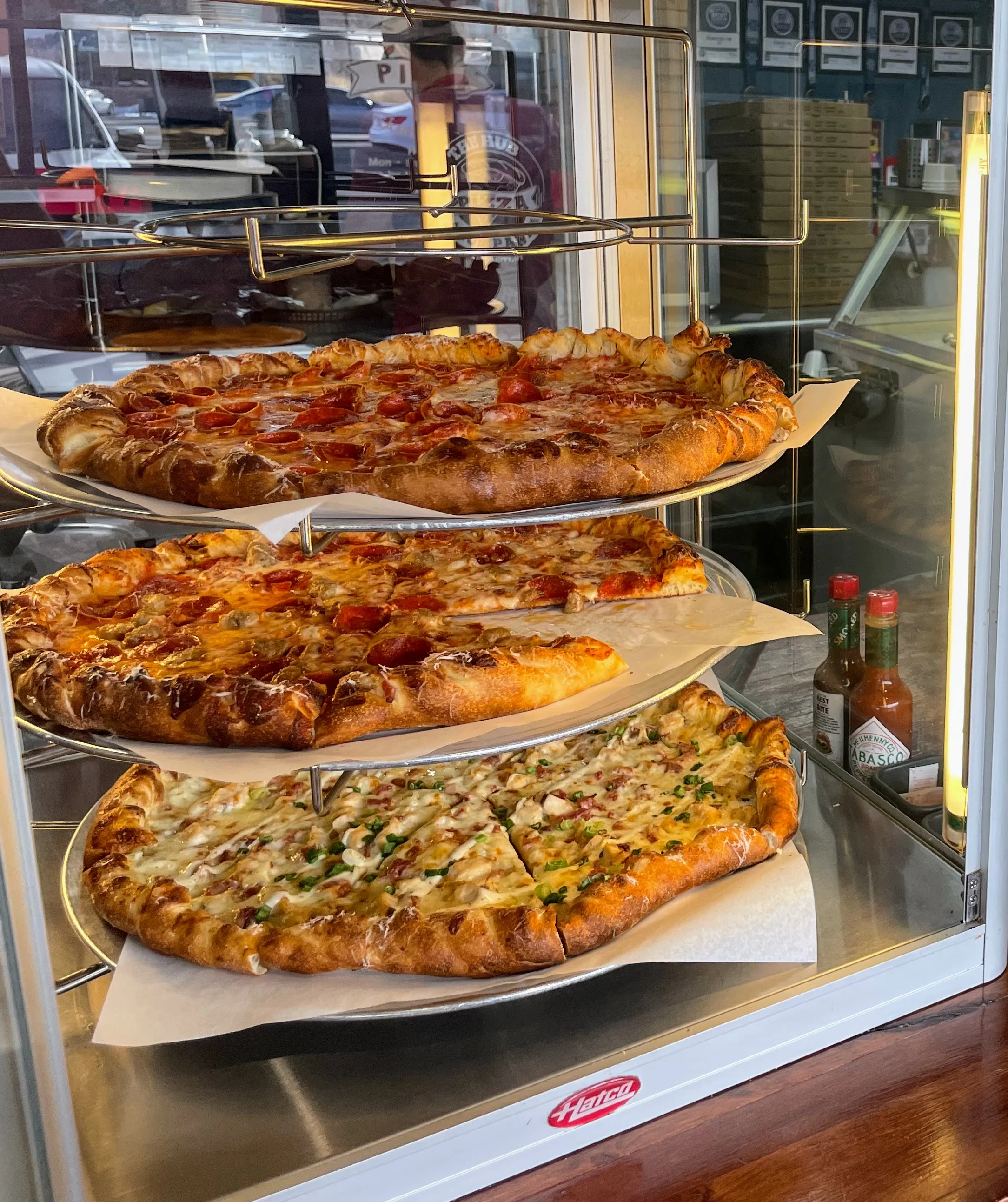 Display of assorted pizzas in a casual dining setting