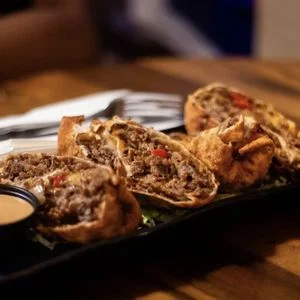 Crispy beef empanadas served with dipping sauce